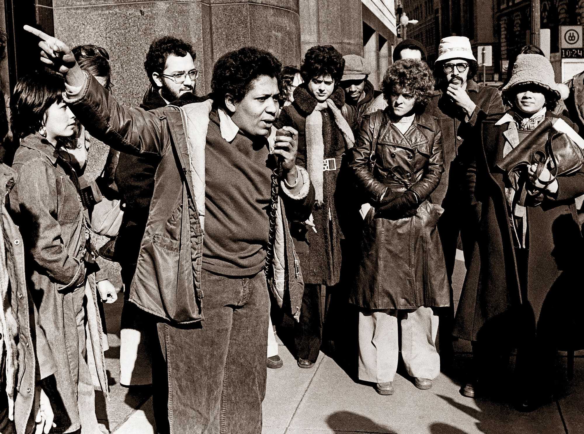 Daisy Diaz, spokesperson for the Comité de Padres, spoke to a crowd gathered outside of the US District Court in 1976. Diaz addressed those at the courthouse after US Judge W. Arthur Garrity Jr. had denounced the city's lack of financial support for the schools as students and families struggled to adapt to desegregation.