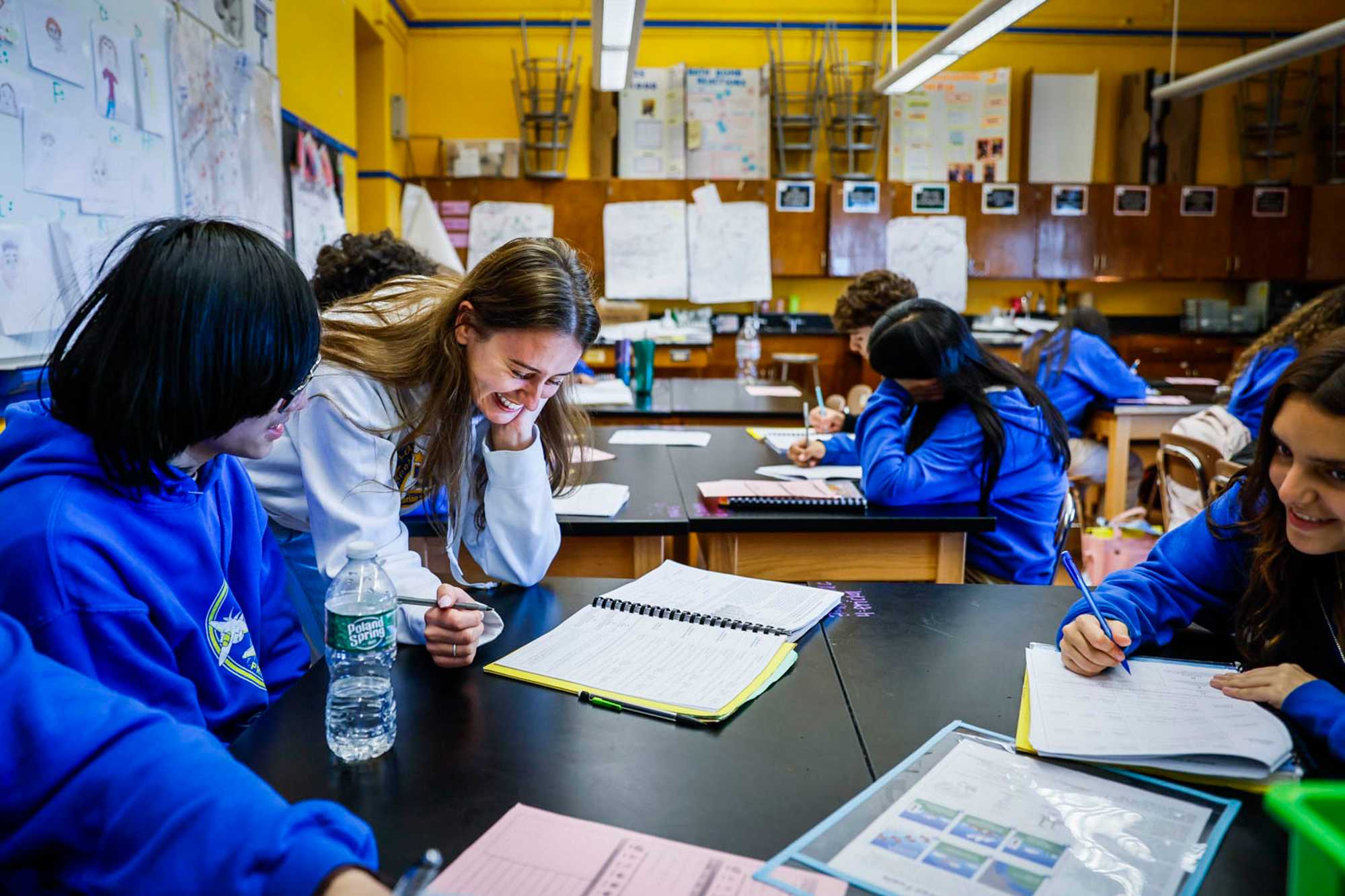 East Boston High School science teacher Molly Mus worked with her students in their classroom on May 17. In some ways, East Boston High stacks up against the exam schools with the number of offerings it has for students. (Erin Clark/Globe Staff)