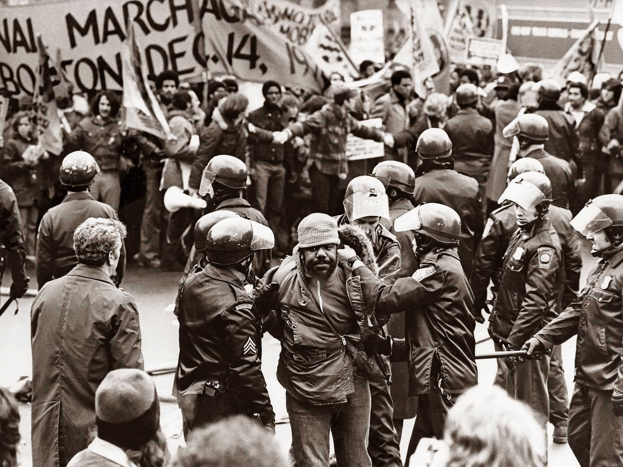 police arrested a man during a pro-busing rally on Boylston Street in Boston on Dec. 14, 1974, months after the start of court-ordered busing to desegregate Boston Public Schools. (George Rizer/Globe Staff)