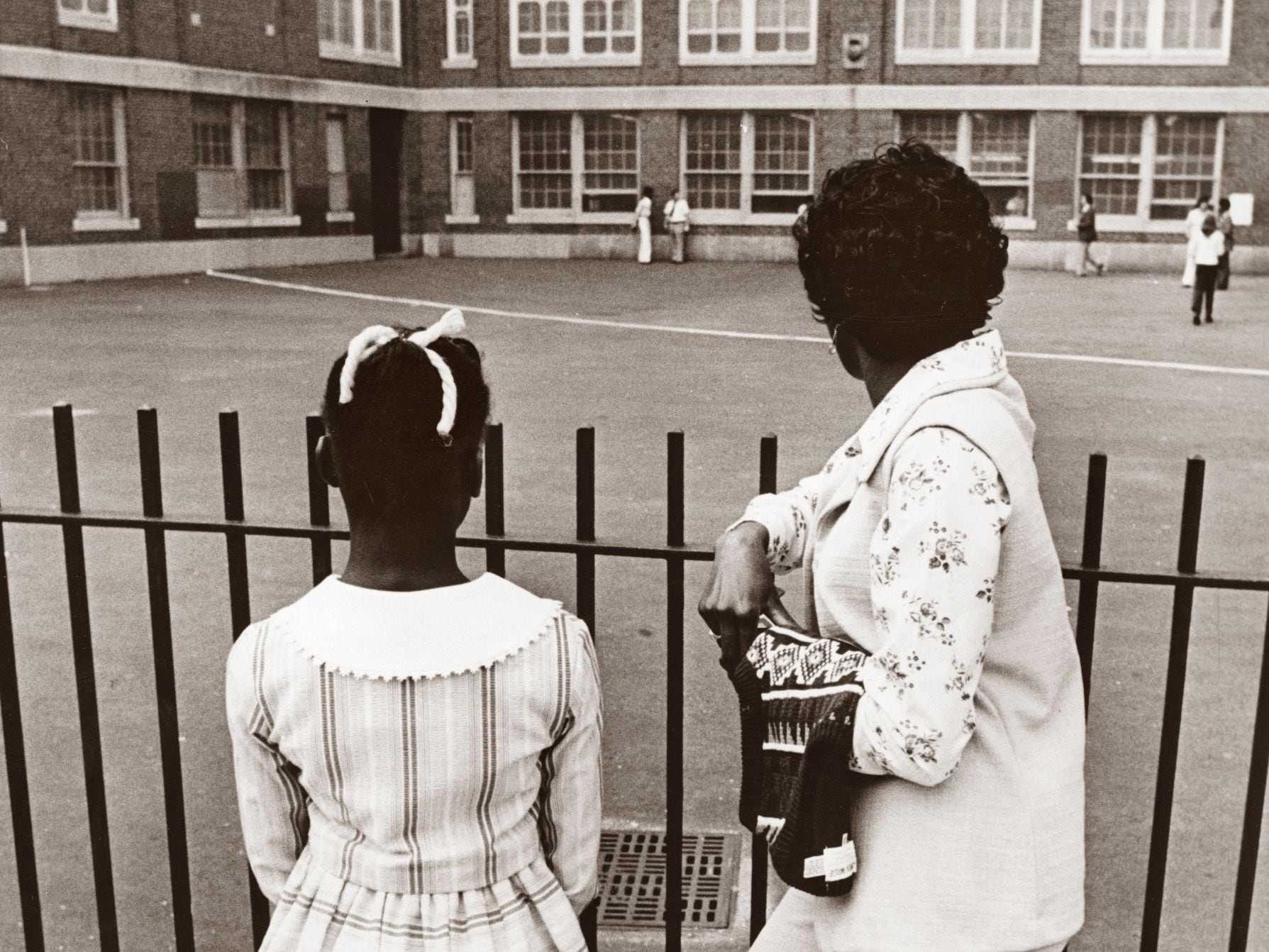 A mother and daughter paused outside the fence before entering Gavin School in South Boston on Sept. 12, 1974.