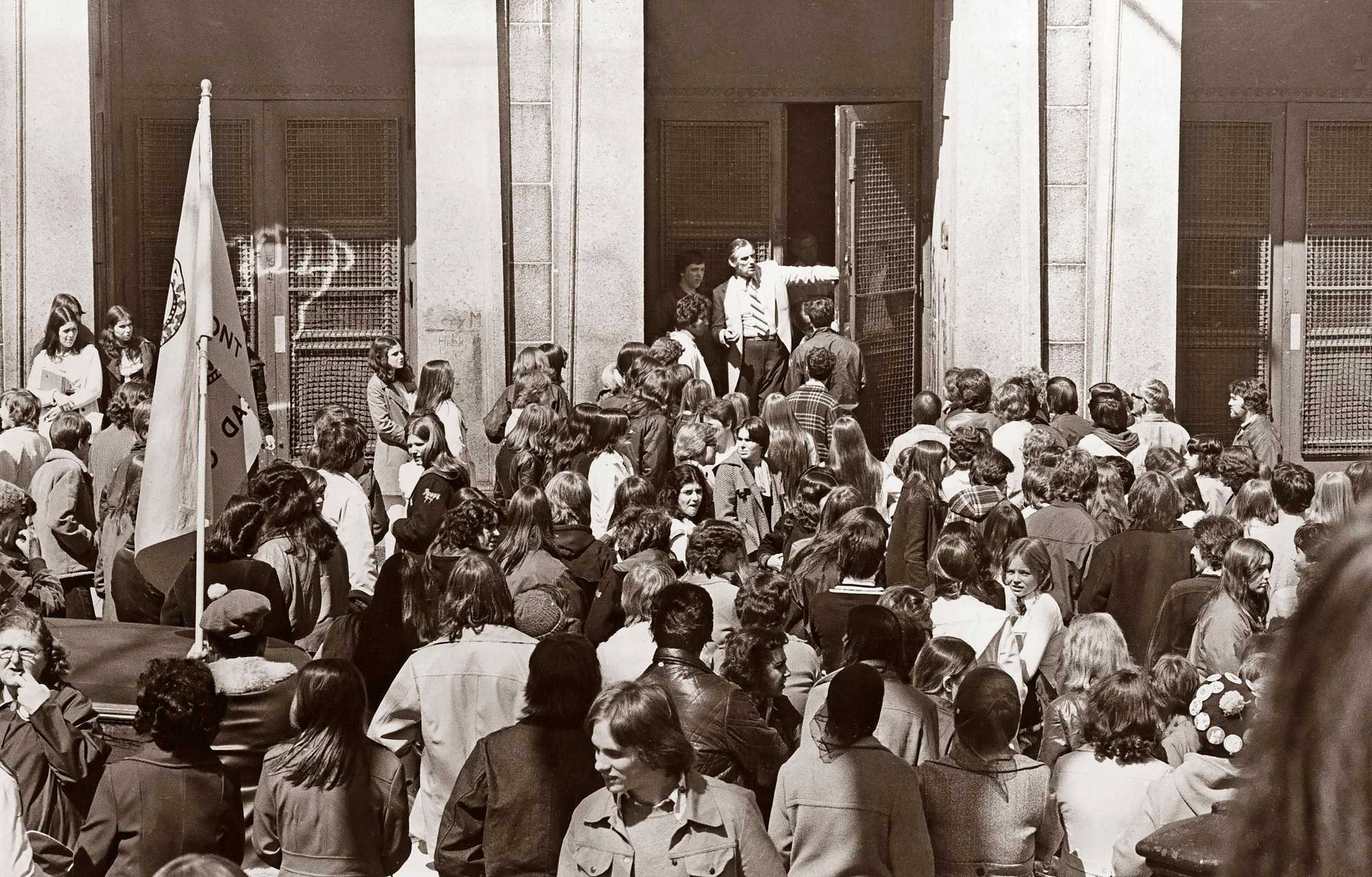Charlestown High School headmaster Frank Powers tried to close the doors after students walked out of classes in protest before noon on April 14, 1975.