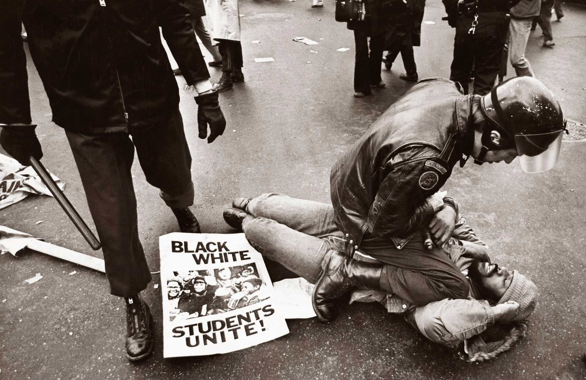 A Tactical Patrol Force officer pinned a demonstrator to the ground during a pro-busing demonstration in Boston on Dec. 14, 1974.