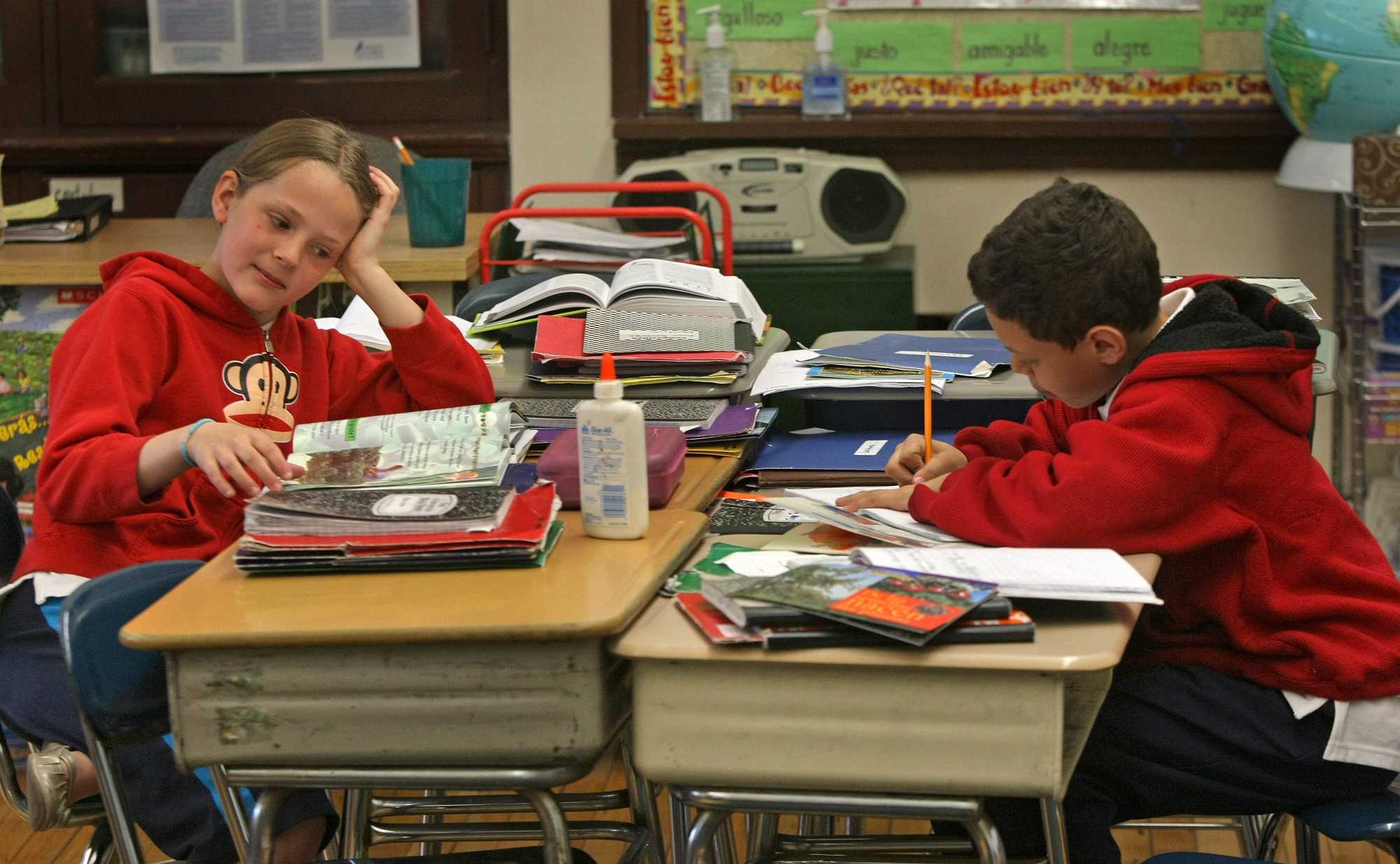 From left, third-grade students Shaina Jewett-Wolf and Jovan Talavera worked at their desks in the Rafael Hernández School in 2009, where native speakers of English and Spanish sit side-by-side in classrooms, receiving instruction in both languages. 