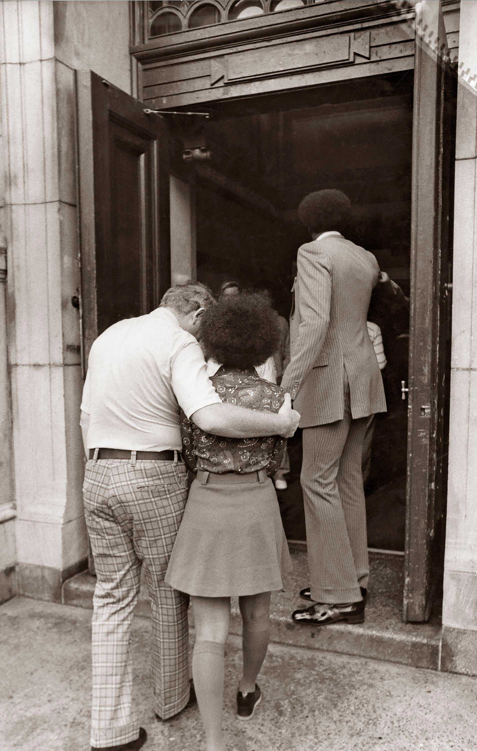 Roxbury High School principal Charles Ray supported a student as they walked into the school the first day of school on Sept. 12, 1974. 