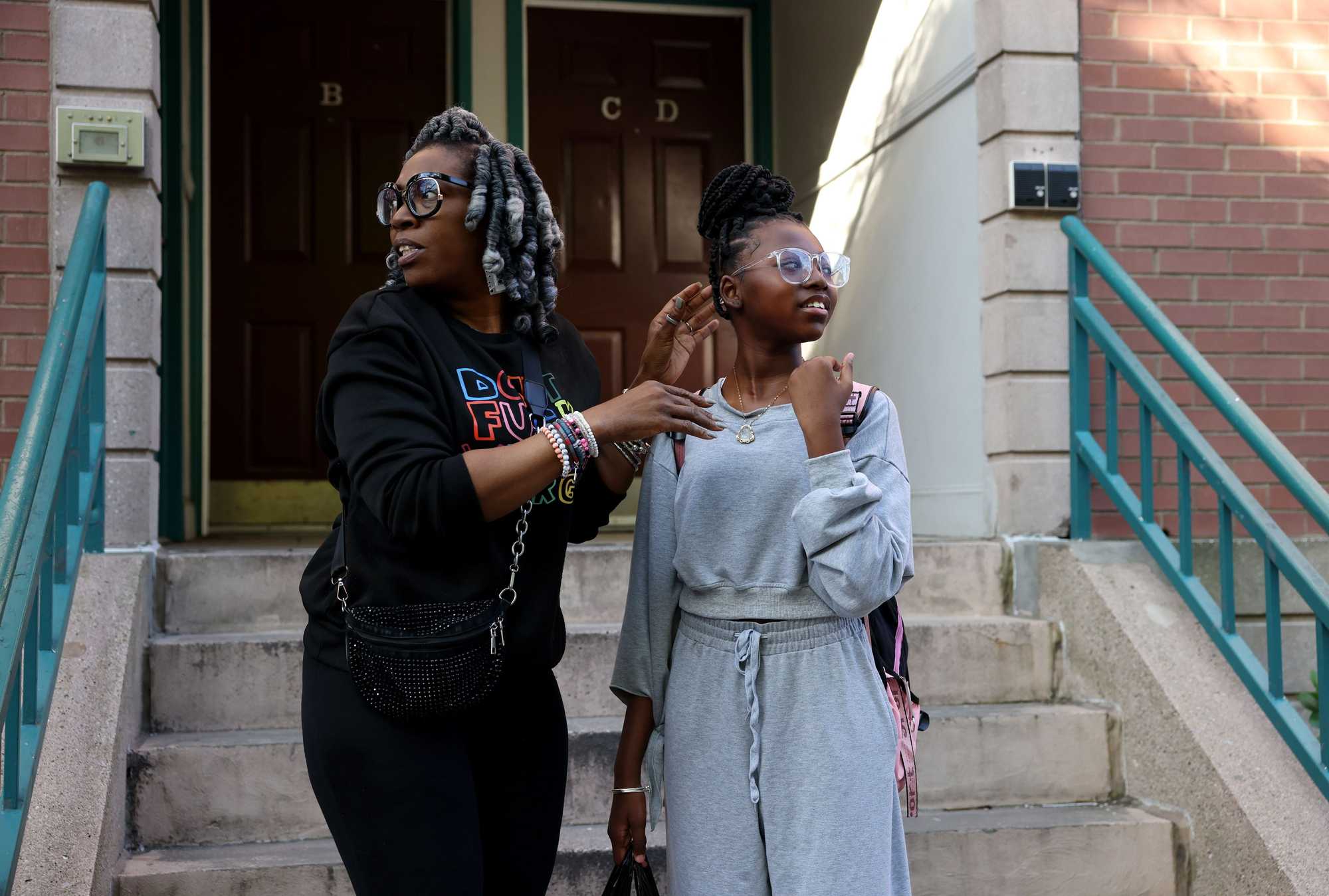 Soneia Bowens of Boston looked over her shoulder to check for the school bus as she fixed the braids of her 12-year-old daughter, Laren, while the pair waited for the bus one May morning. 