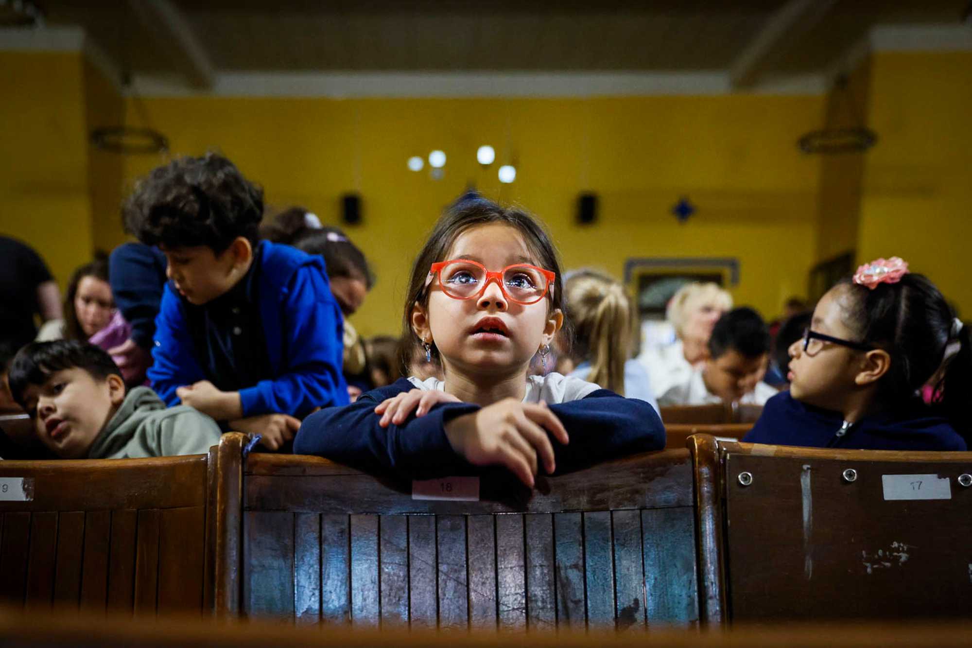 Elementary school children attended a concert in East Boston High School’s auditorium. While the city contemplates what it will do to fix the school system, parents and students wait, hoping for a better shot at an equal education.

