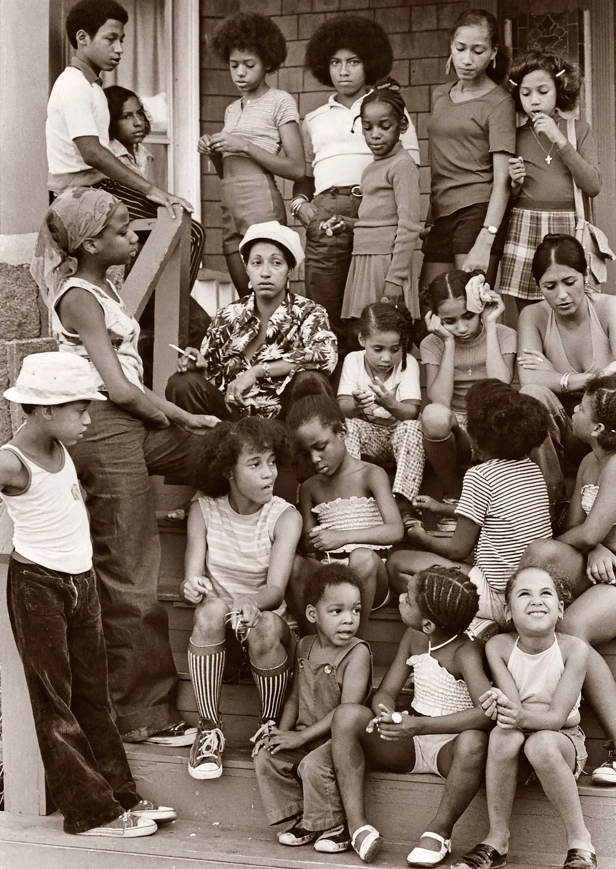 Families whose children were bused to new schools sat outside of a Mattapan house on Sept. 13, 1974, the second day of school under court-ordered busing.