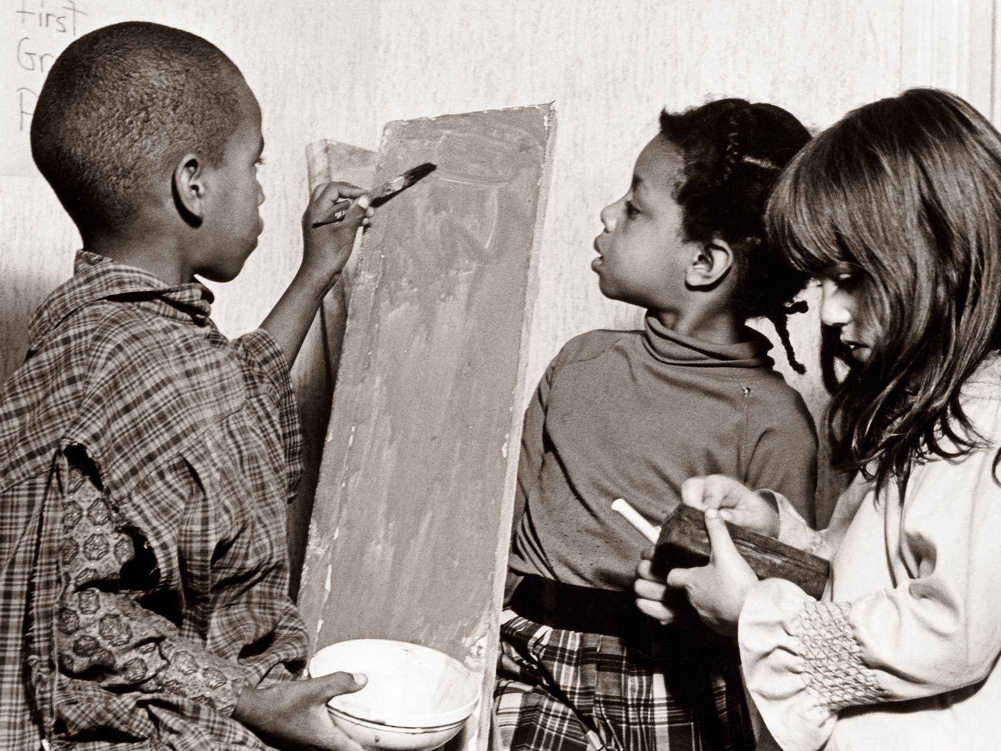 Students painted together in 1966 at the Roxbury Community School, one of many institutions that opened as alternatives for Black students failed by Boston Public Schools. (Charles Dixon/Globe Staff)