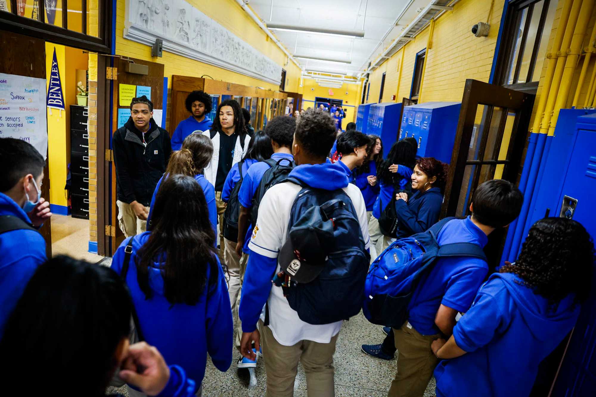 A sea of blue sweat shirts filled the hallway at East Boston High after students left lunch and headed to class. Because of the neighborhood’s isolation, East Boston largely escaped court-ordered busing and relies less on school choice today. (Erin Clark/Globe Staff)