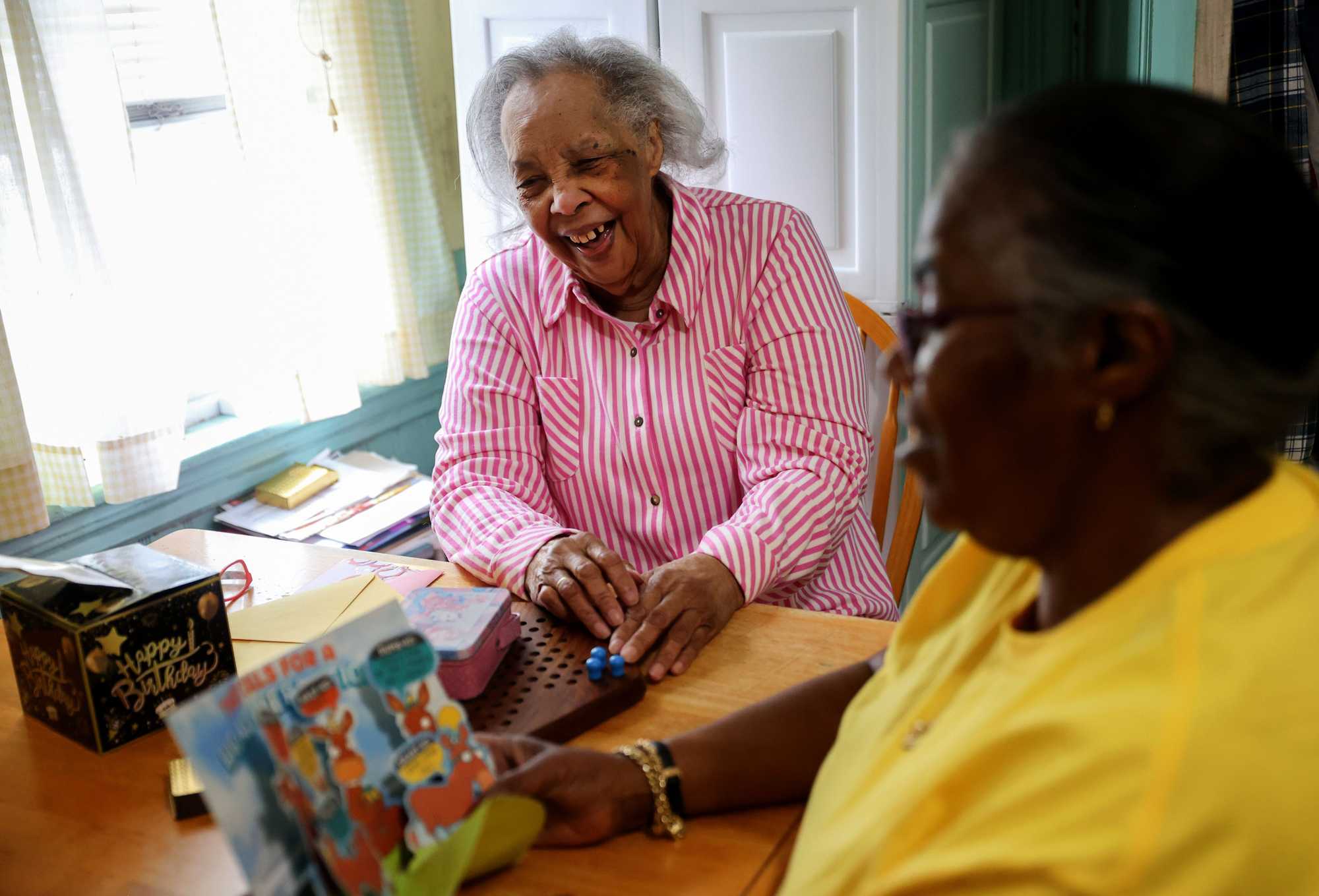 Earline Pruitt enjoyed a laugh on her 90th birthday at home with her daughter Betty Weeks, at right. (Jonathan Wiggs /Globe Staff) 