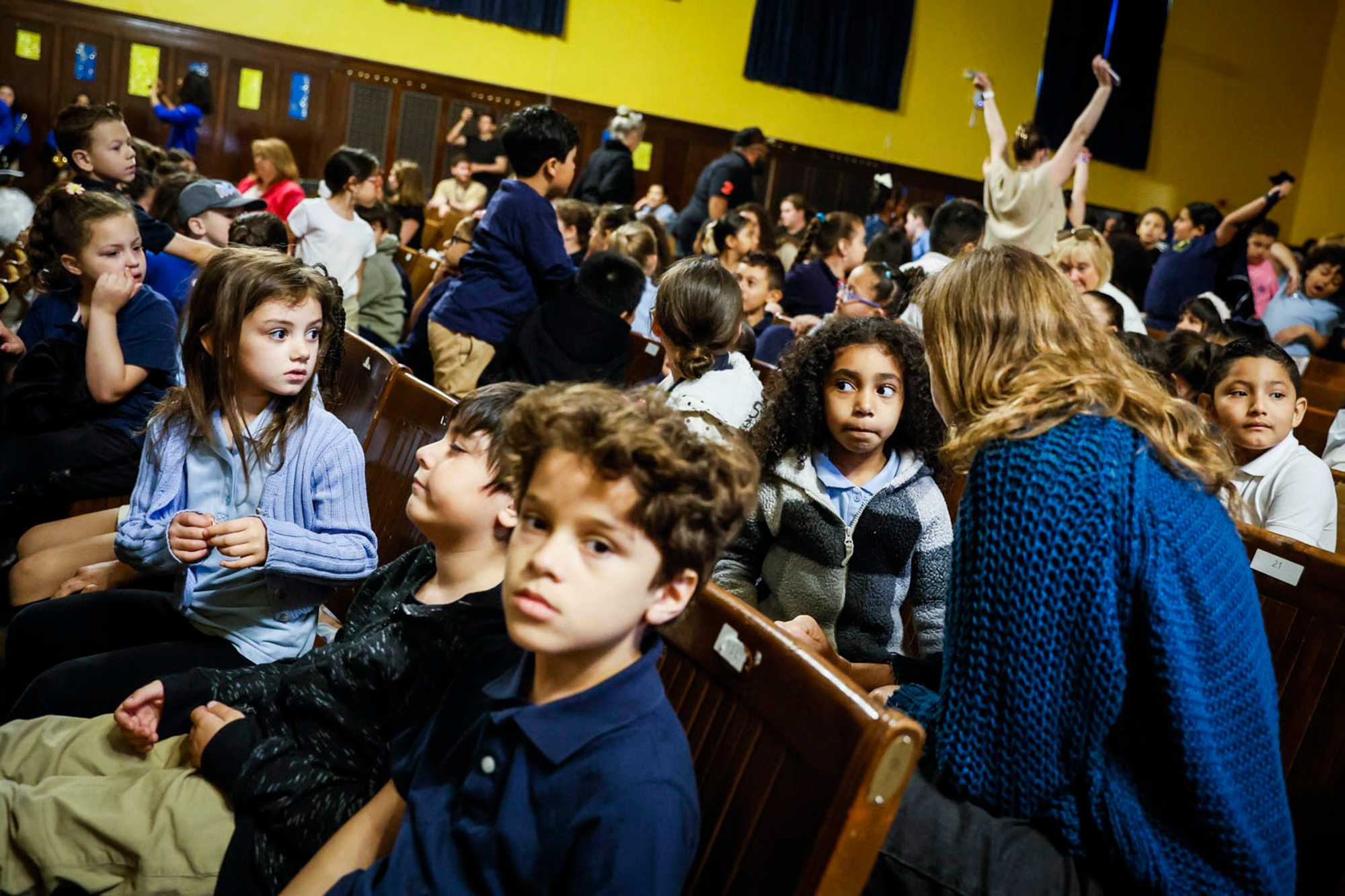 In East Boston High's auditorium, a concert was held featuring children from nearby elementary schools. Neighborhood residents get priority to attend East Boston schools, and they choose them partly because they feel a sense of ownership of them. (Erin Clark/Globe Staff)