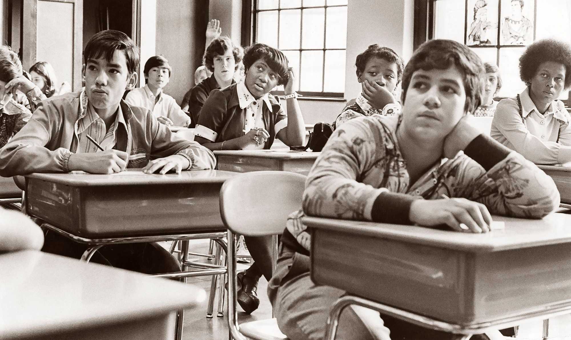 Eighth-grade students participated in an integrated classroom at the Mary E. Curley School in Jamaica Plain on Sept. 12, 1974, the first day of school under the new busing system put in place to desegregate Boston Public Schools. 