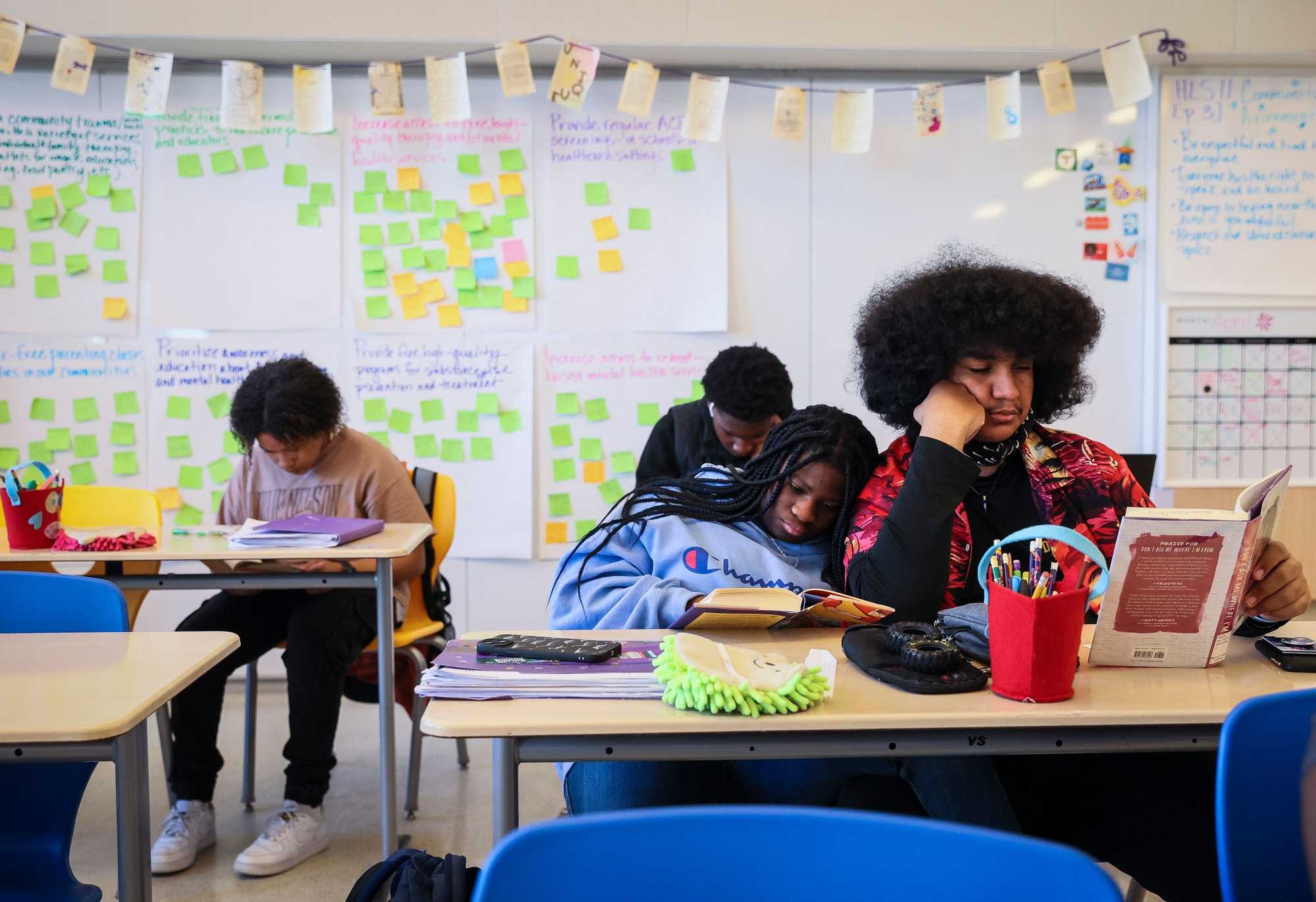 Eboni Maxwell leaned on the shoulder of Emmanuel Vargas while they read in their language arts class at the Dearborn STEM Academy in Roxbury on April 26.