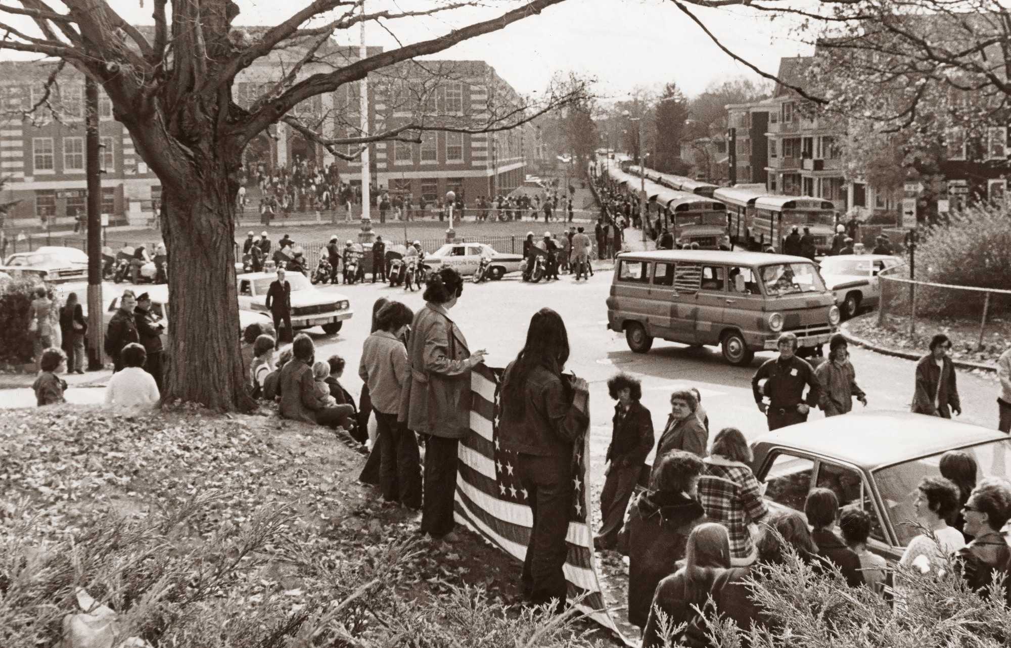 The scene outside as buses left Hyde Park High School in Boston on Oct. 28, 1974.  (Paul Connell/Globe Staff) 