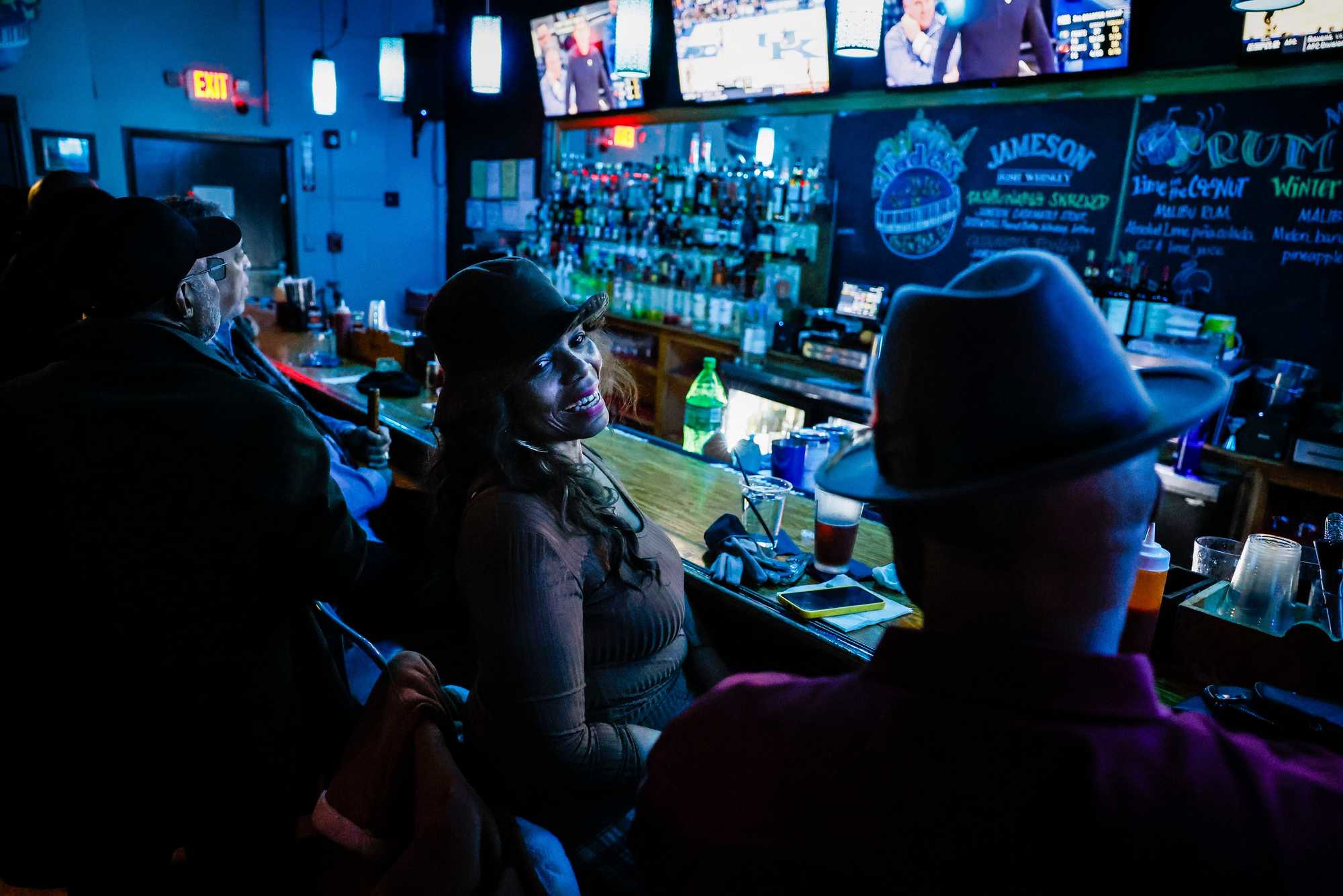 Longtime patrons shared a laugh at the bar during jazz night at Slade's Bar and Grill in Boston. The historic establishment, a fixture on Tremont Street since 1935, has hosted the WeJazzUp band for nearly 25 years, continuing its legacy as one of Boston's enduring venues from "The Negro Motorist Green Book" era. 