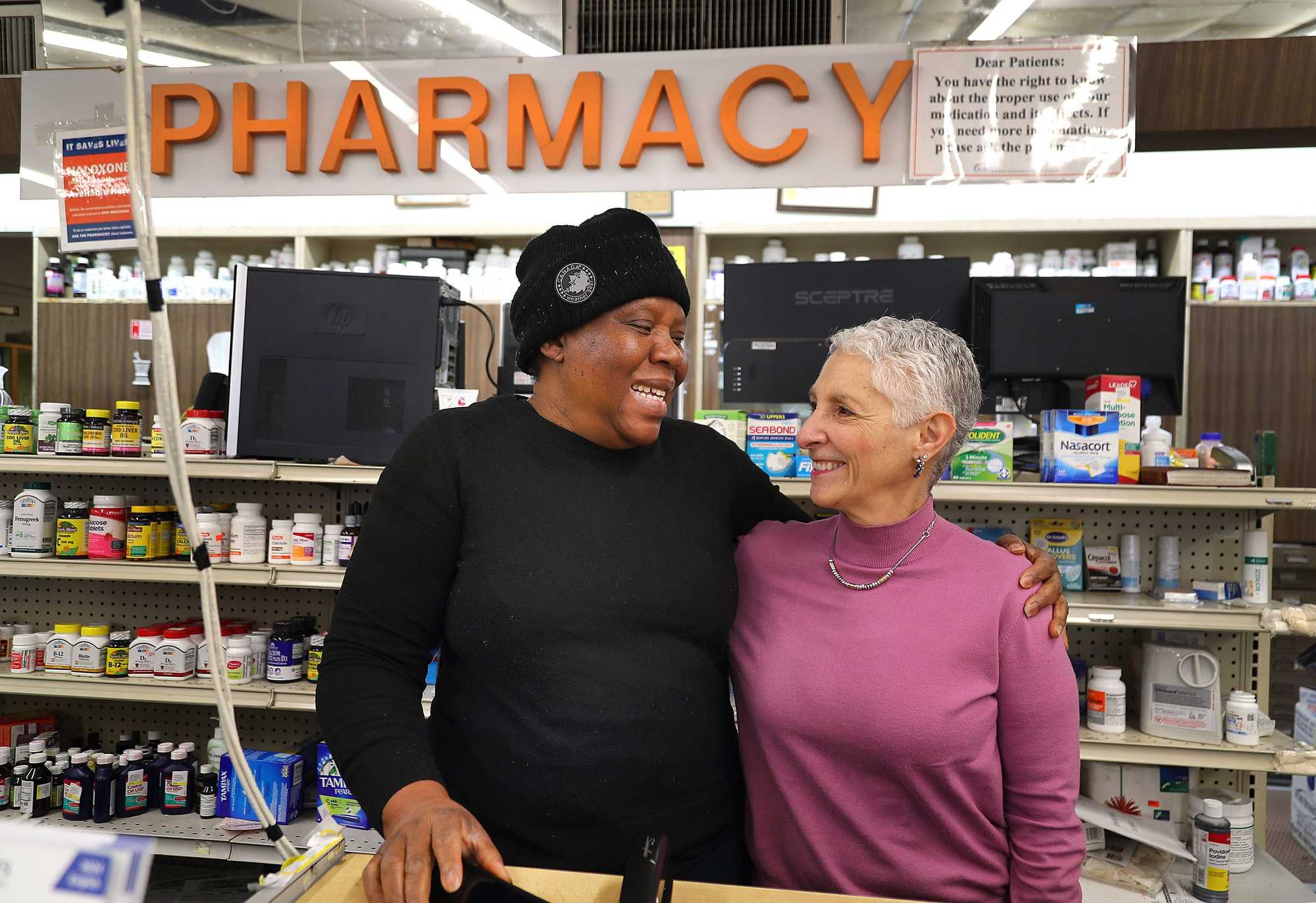 At Kornfield Pharmacy in Nubian Square, Sharon Kamowitz (right), granddaughter of its second Jewish owner, Henry Shapiro, met current owner, Esther Egesionu, inside the pharmacy for the first time. Esther took ownership after her husband was killed.