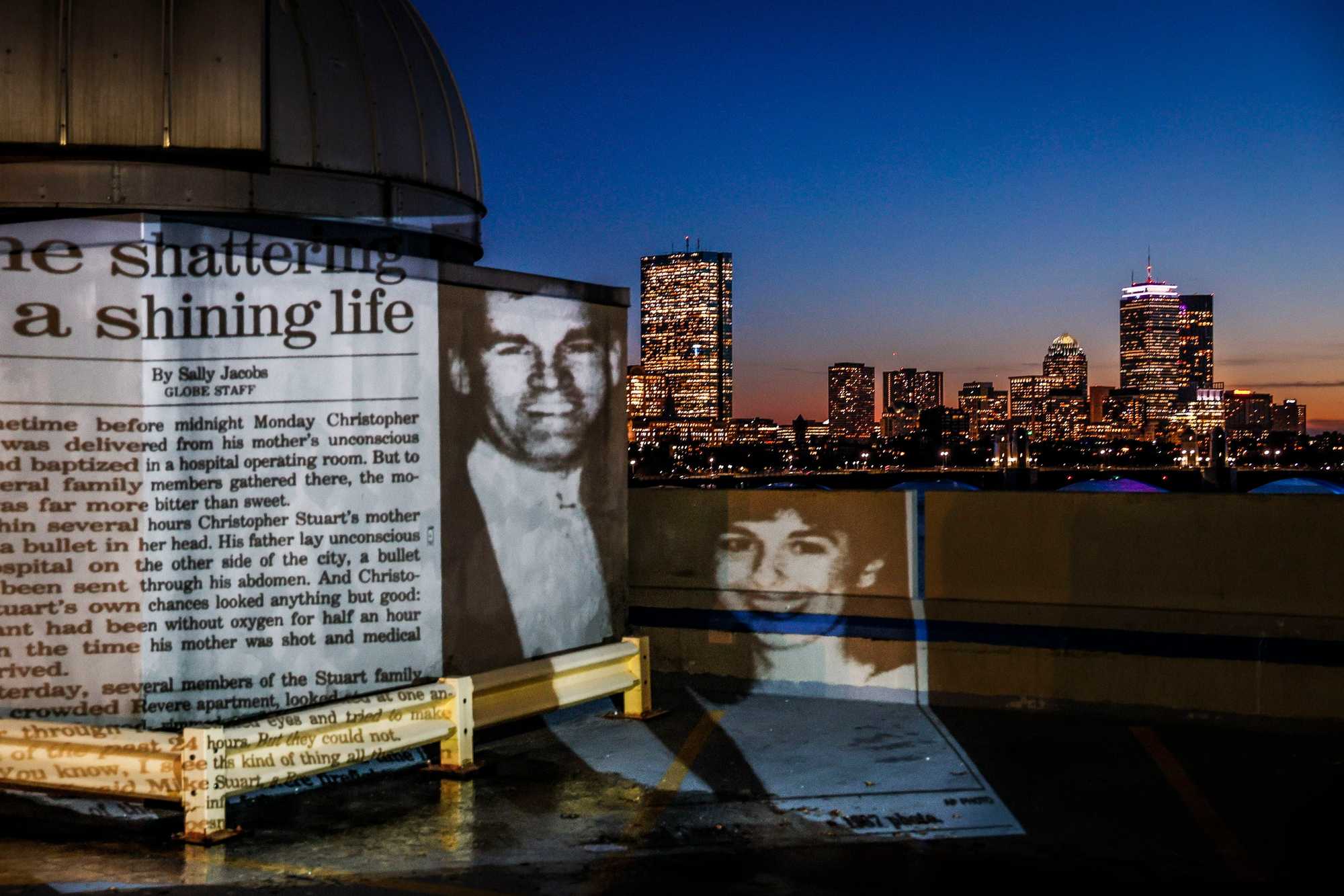 SPOTLIGHT - CHARLES STUART CAMBRIDGE, MA - 11/20/2023 A projection of a Boston Globe article from October 25th, 1989 is projected with the Boston city skyline. Erin Clark/Globe Staff 