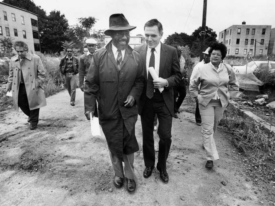 Boston, MA - 8/31/1985: Boston Mayor Ray Flynn walks with Dan Richardson of the Trotter Neighborhood Association, left, during a press conference announcing the development of a vacant lot off Hollander Street in Boston on Aug. 31, 1985.  (John Blanding/Globe Staff) --- BGPA Reference: 170407_BS_029