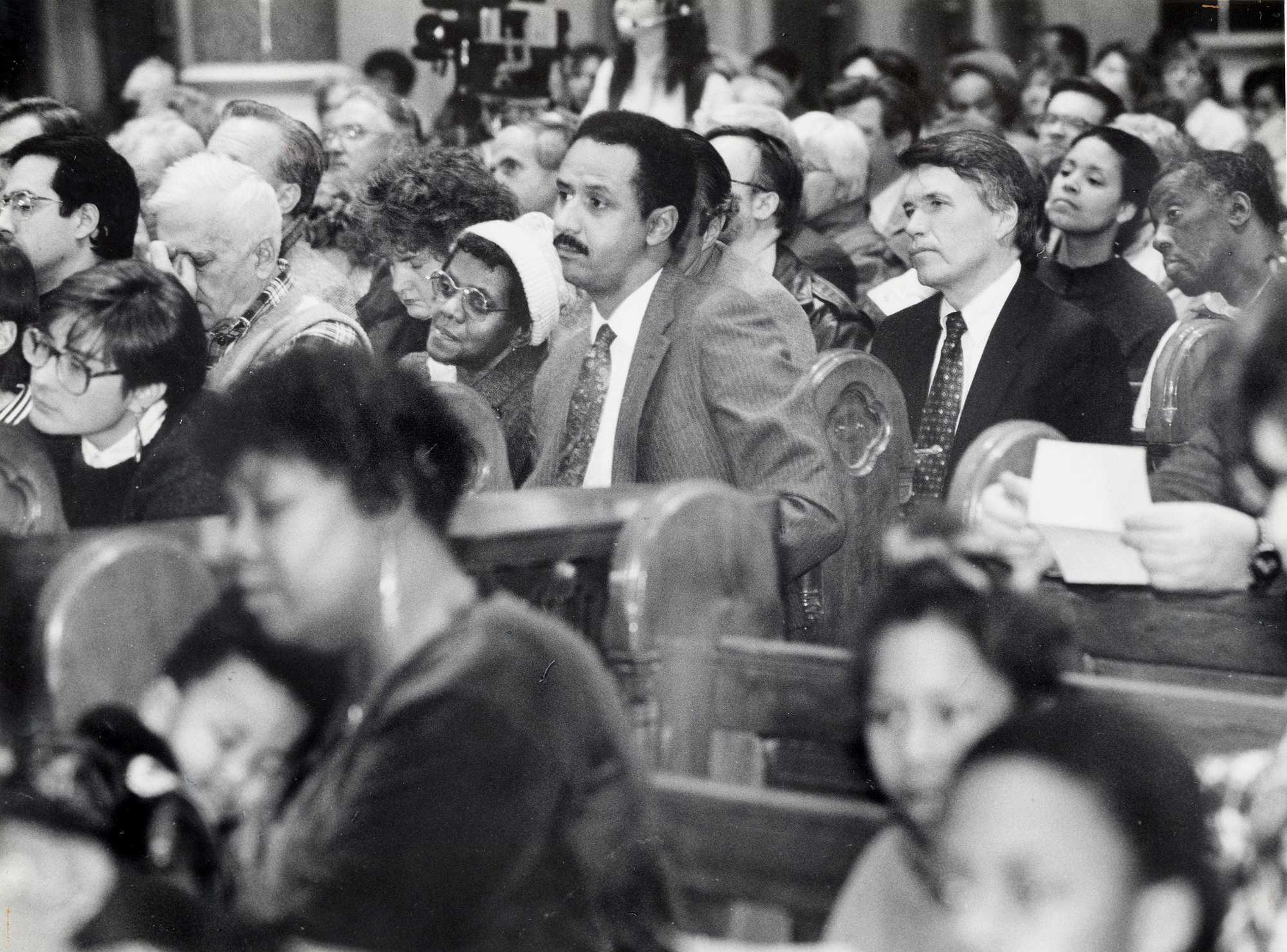 Hundreds of people including Boston Police Commissioner Francis M. "Mickey" Roache (right center) gathered for a prayer service at the Mission Church in Mission Hill on Jan. 9, 1990. About three months prior, 300 people came to Mission Church to pray for Carol and Charles Stuart, who were shot on Oct. 23, 1989.