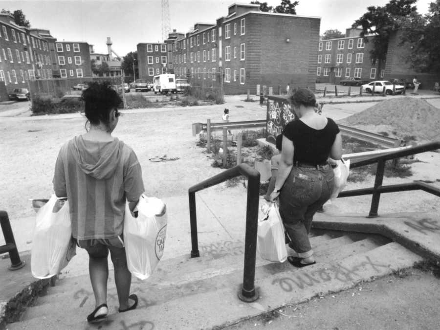 Print scan for Metro/ Globe staff file Evan Richman two women walk through Mission Hill housing projects. which was due for 50 million renovation. Merlin Photo