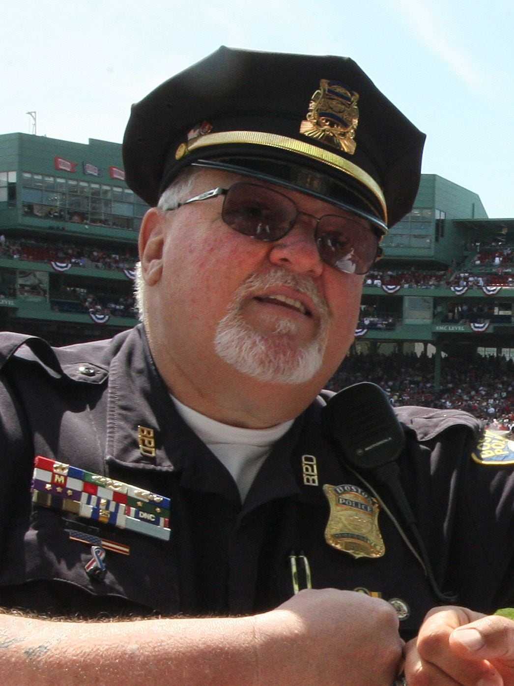 Boston Police officer Billy Dunn fist bumping former Sox closer Keith Foulke at Fenway's 100th birthday celebration in 2012. (Stan Grossfeld/The Boston Globe)