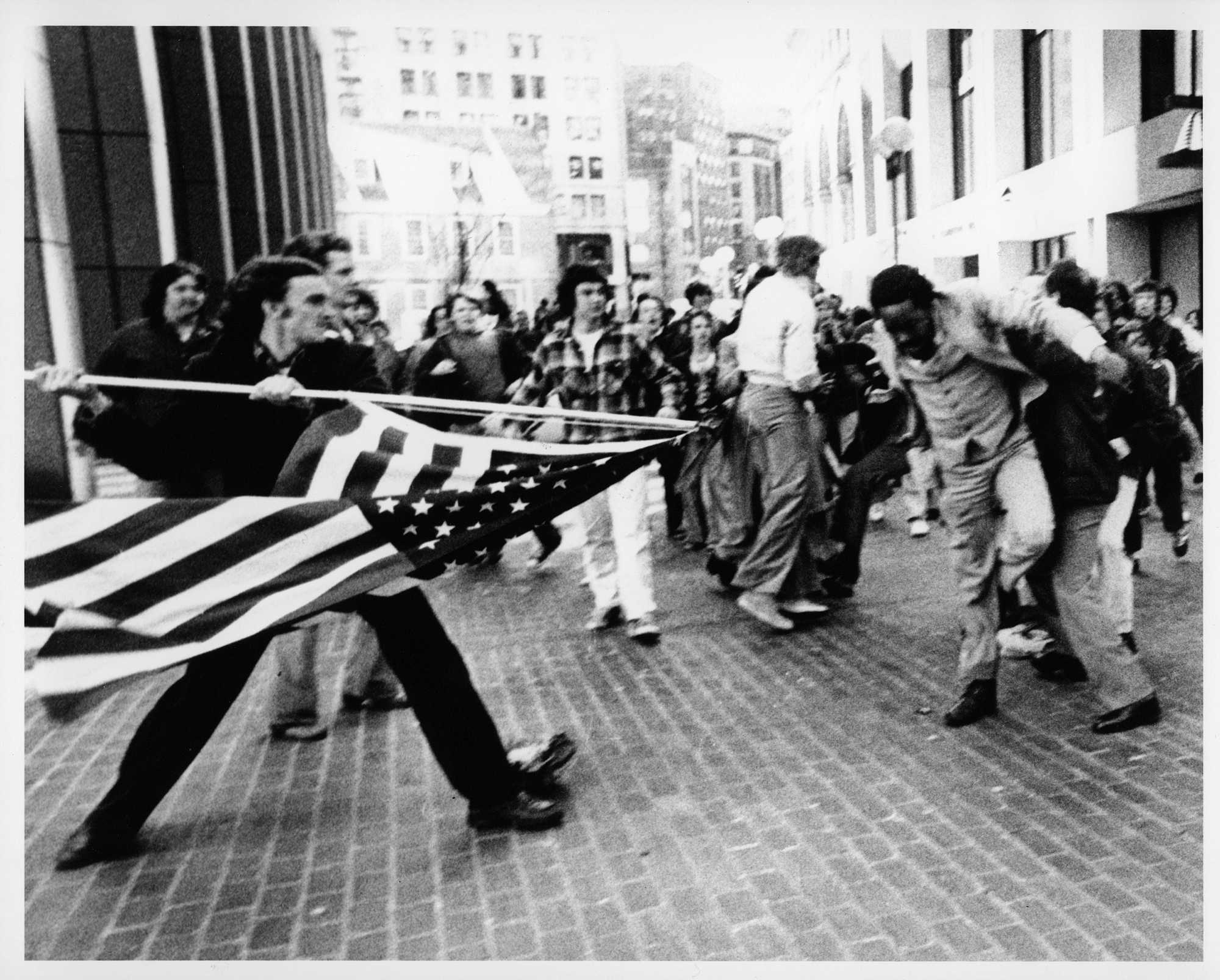 At a Boston rally against forced school busing, white teenager Joseph Rakes brandished an American flag at Ted Landsmark on April 5, 1976. The photo, which would come to be known as "The Soiling of Old Glory," rocketed around the world.