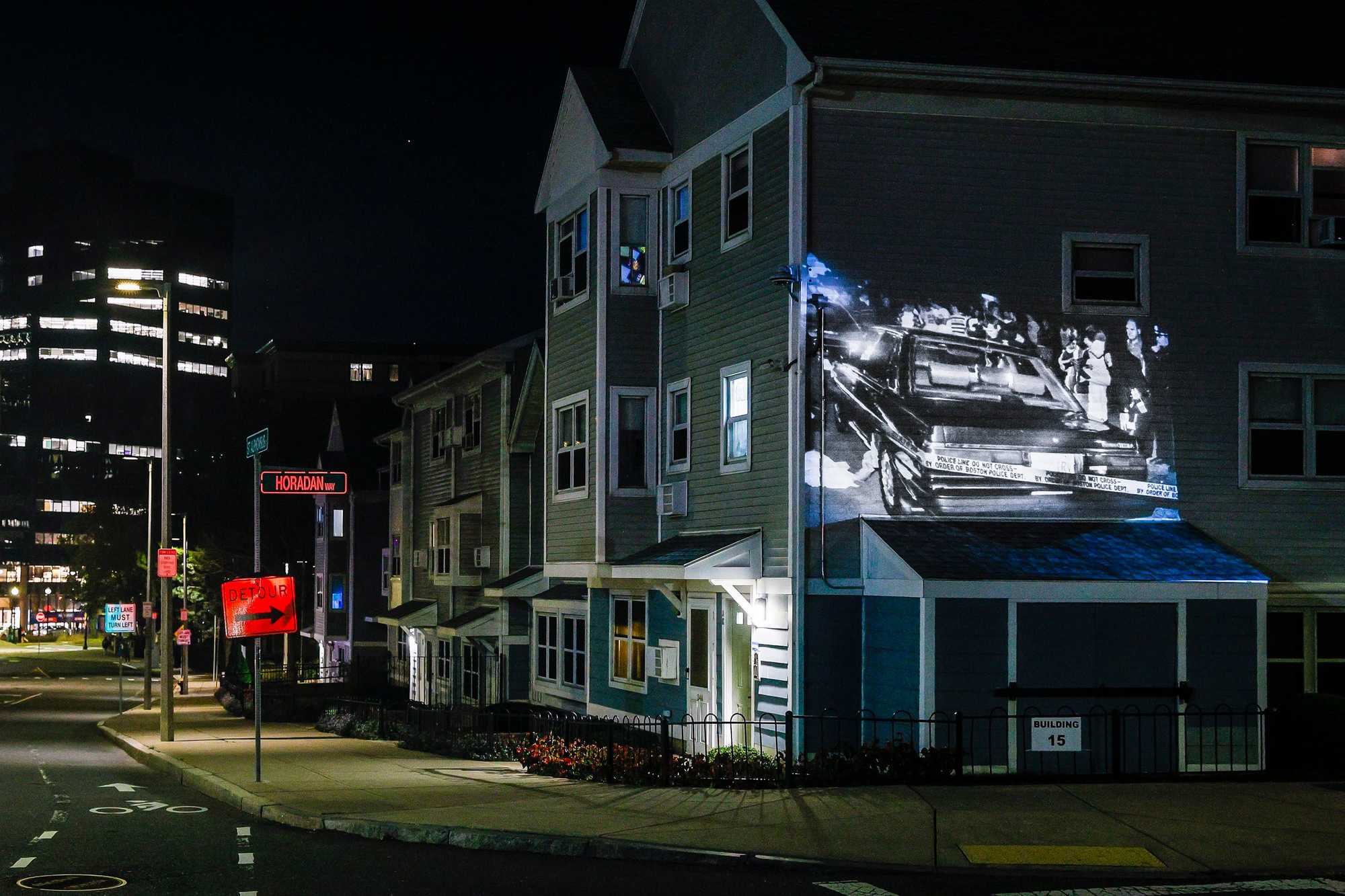A photo of Charles Stuart’s car and the resulting crime scene is projected on St. Alphonsus Street and Horadan Way, near where Carol and Charles Stuart were found shot on the night of Oct. 23, 1989. 
