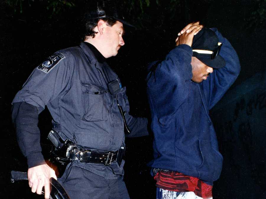 Boston, MA - 1989: A Boston Police officer searches a man in at the Academy Homes housing project. Residents called police after hearing gun shots.  (John Tlumacki/Globe Staff) --- BGPA Reference: 170809_BS_029