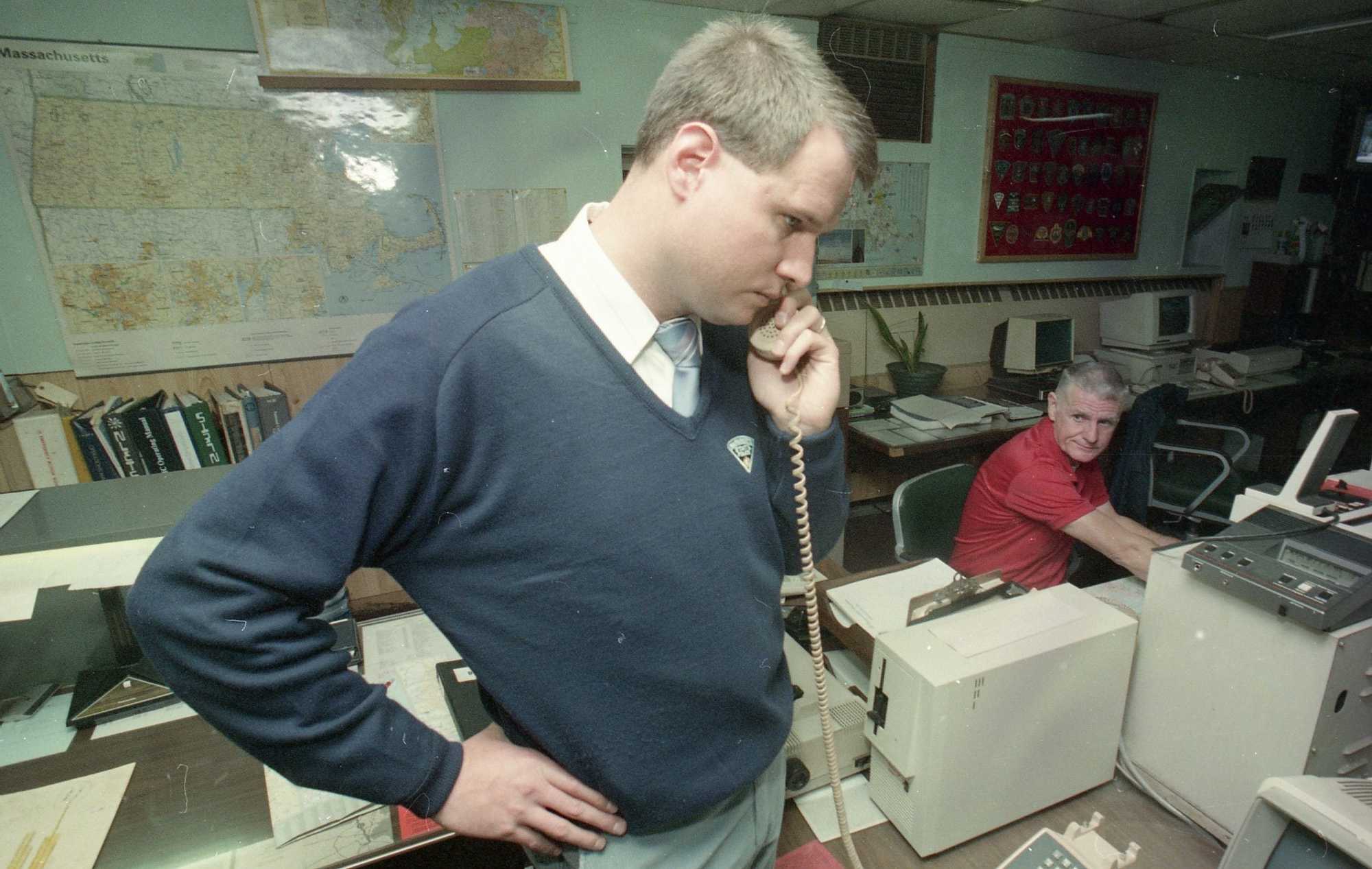 Massachusetts State Trooper Gary McLaughlin worked the phones, while dispatcher Jack Moran did the same in the background at State Police on Oct. 24, 1989. McLaughlin was the dispatcher who spoke with Charles Stuart and helped direct emergency personnel to his location the night of the murder.