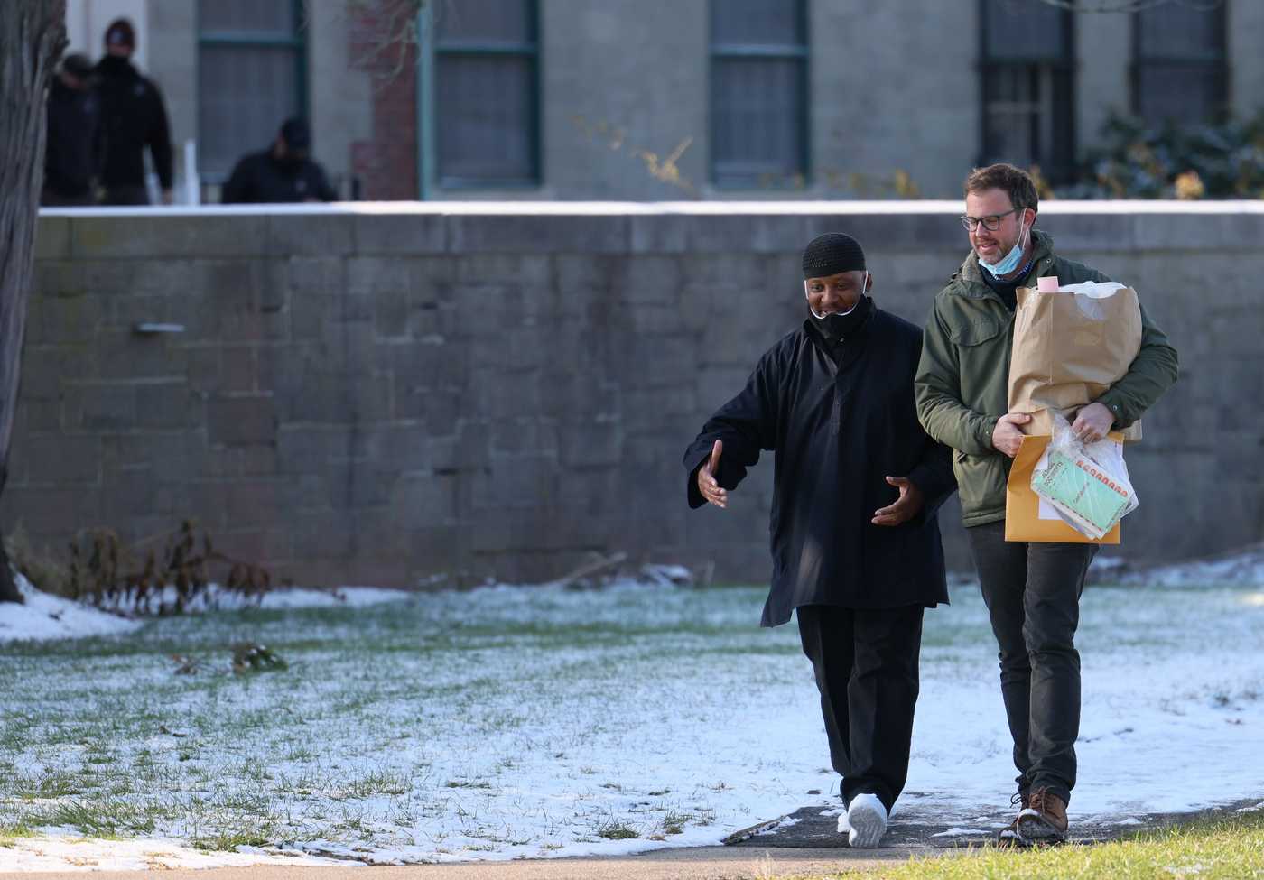 Joseph Jabir Pope (left) might still have to return to prison to finish out his mandatory life sentence, but last December was granted a temporary release pending his felony-murder appeal. He is shown here, minutes after his release, alongside his lawyer, Jeff Harris (right). 