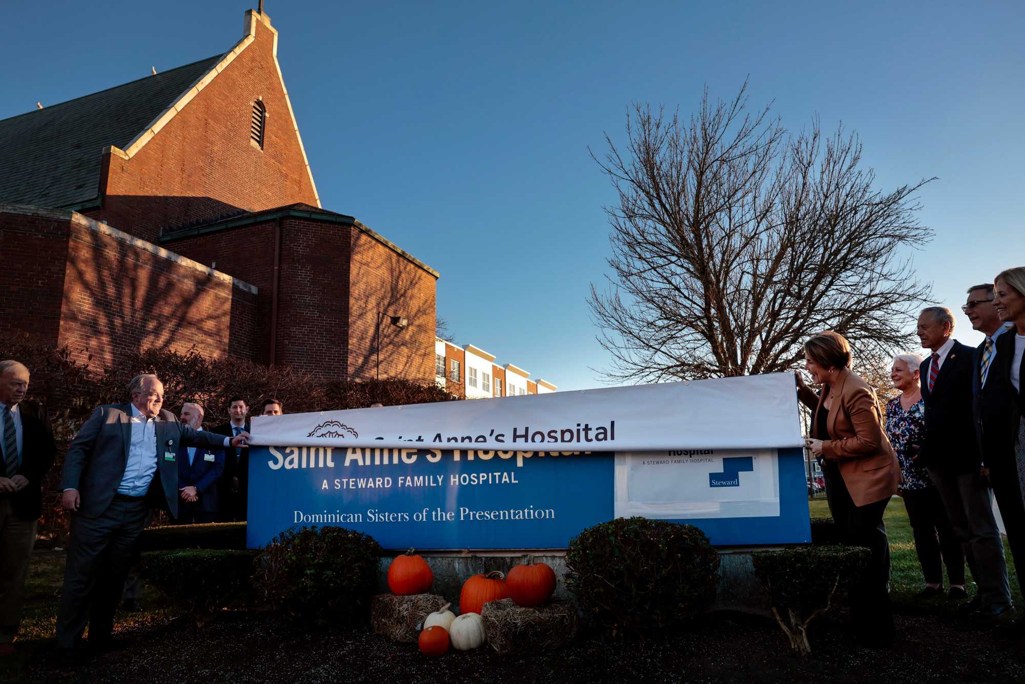 Governor Maura Healey unfurled a Saint Anne's Hospital Brown University Health banner, covering the former Steward Family Hospital sign, during a ceremony at the Fall River hospital last month. The event marked Brown University Health’s acquisition of the former Steward hospital.