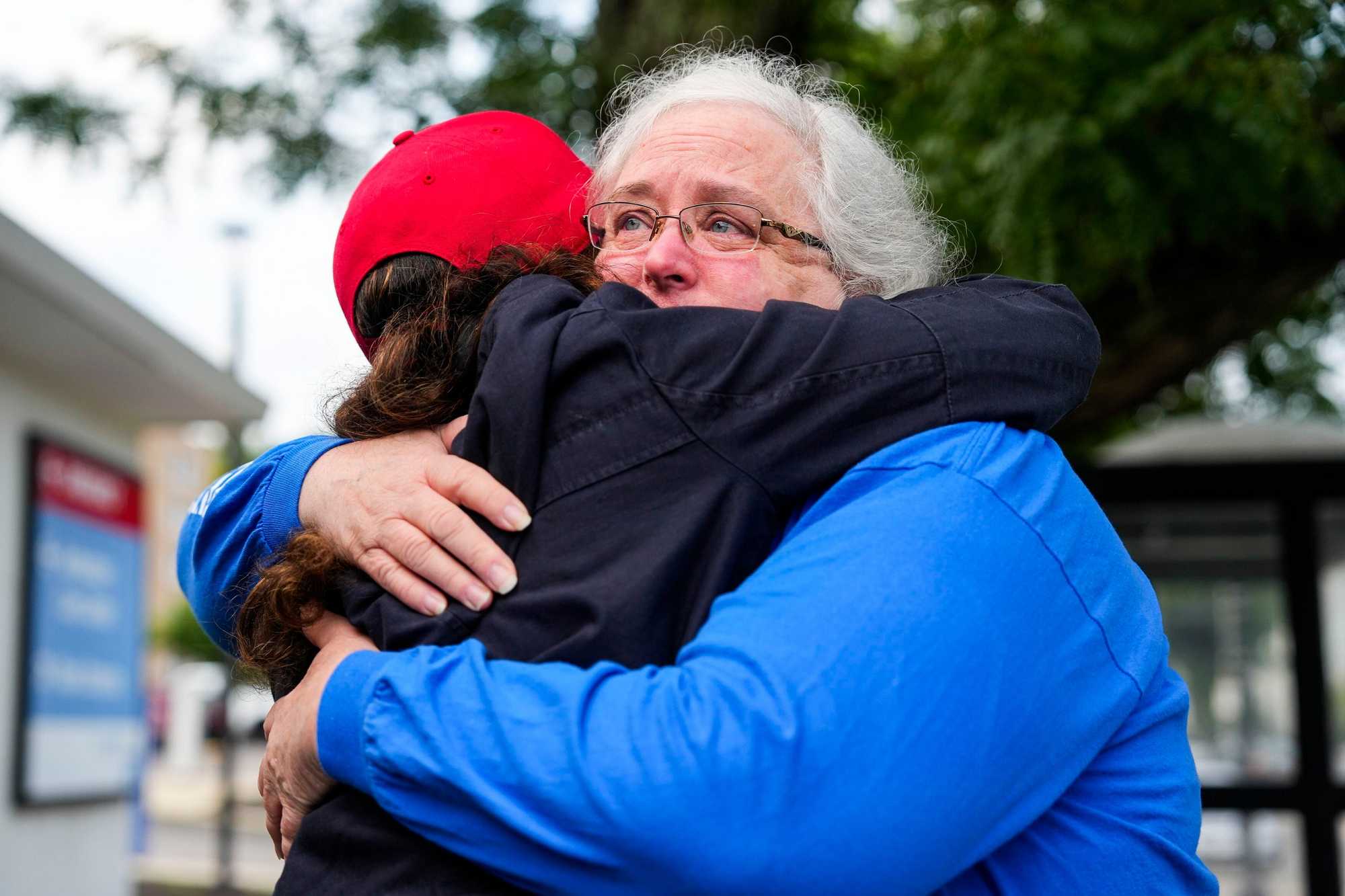 Lead department secretary Maryanne Murphy (right) hugged a friend on Aug. 31, 2024, the day the emergency department at Carney Hospital in Dorchester closed.