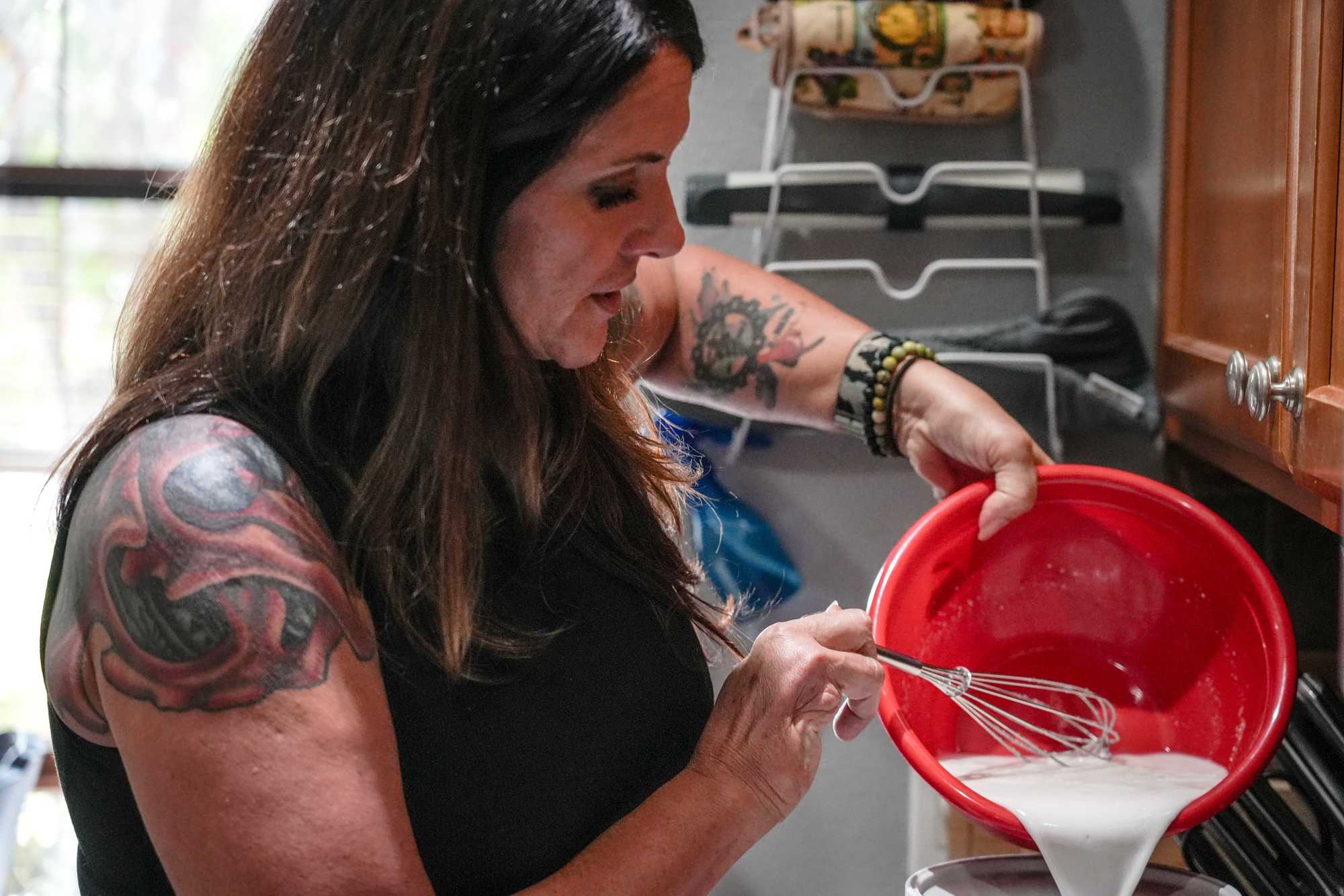 Melissa Williams makes ice cream at the Melbourne home where she and her 14-year-old son are staying.  