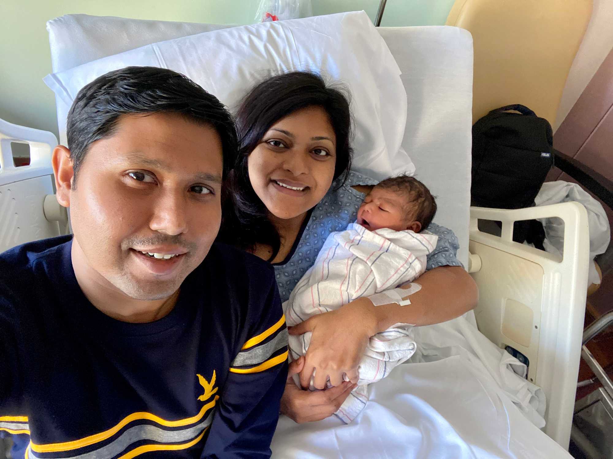 Nabil Haque and Sungida Rashid with their newborn daughter, Otindria, on the morning of her birth.