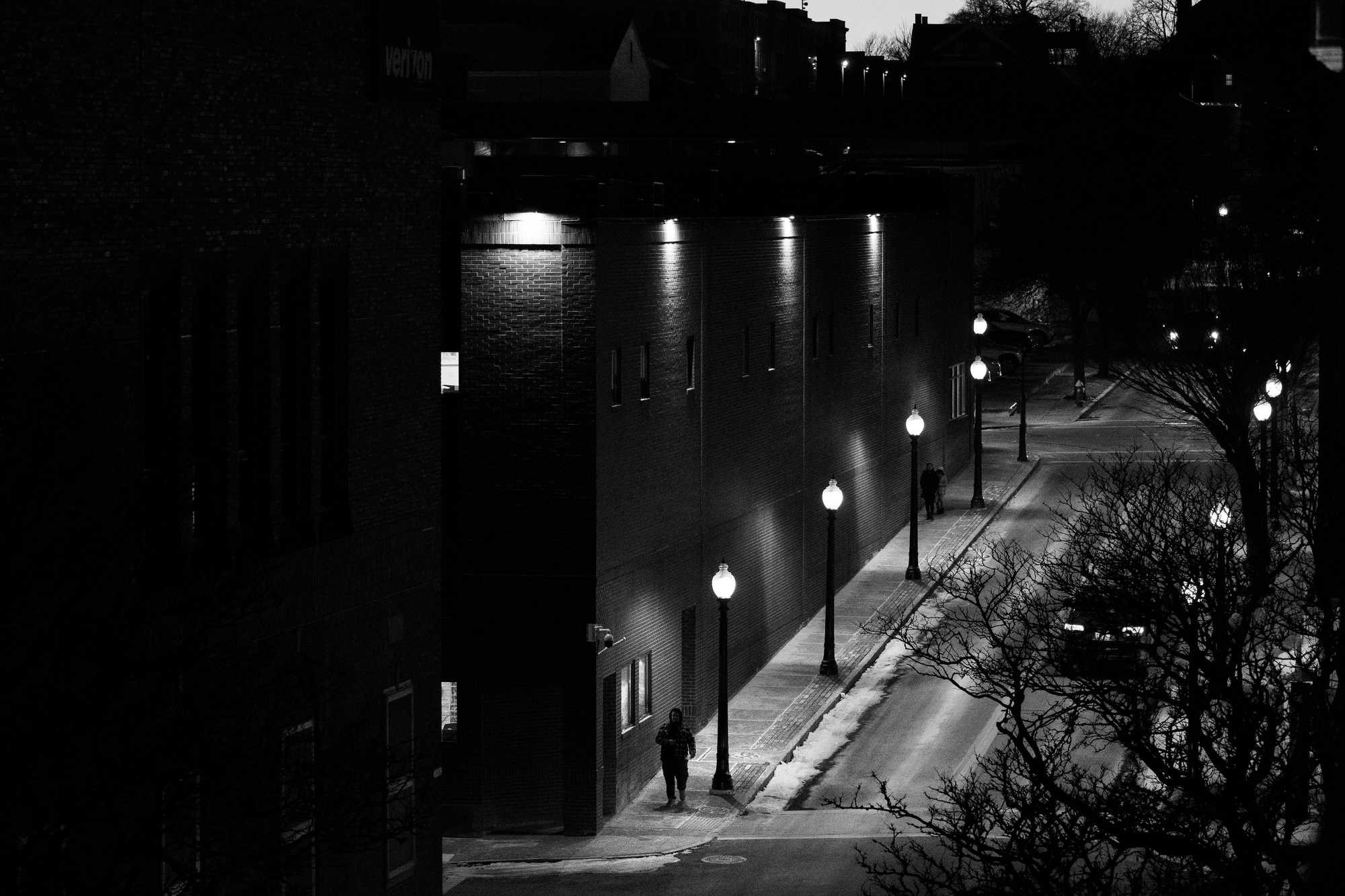  A pedestrian on Elm Street walked in the gathering dark of downtown New Bedford.  