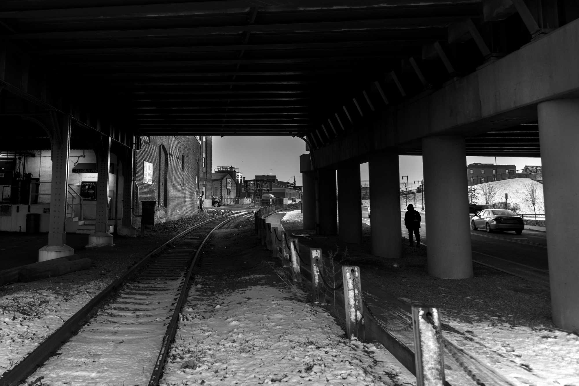 The New Bedford-Fairhaven Bridge cast a shadow over MacArthur Drive. Fisherman Alfredo "Freddy" Loya once confronted Officer Jorge Santos here after Santos allegedly stole pills from him. 