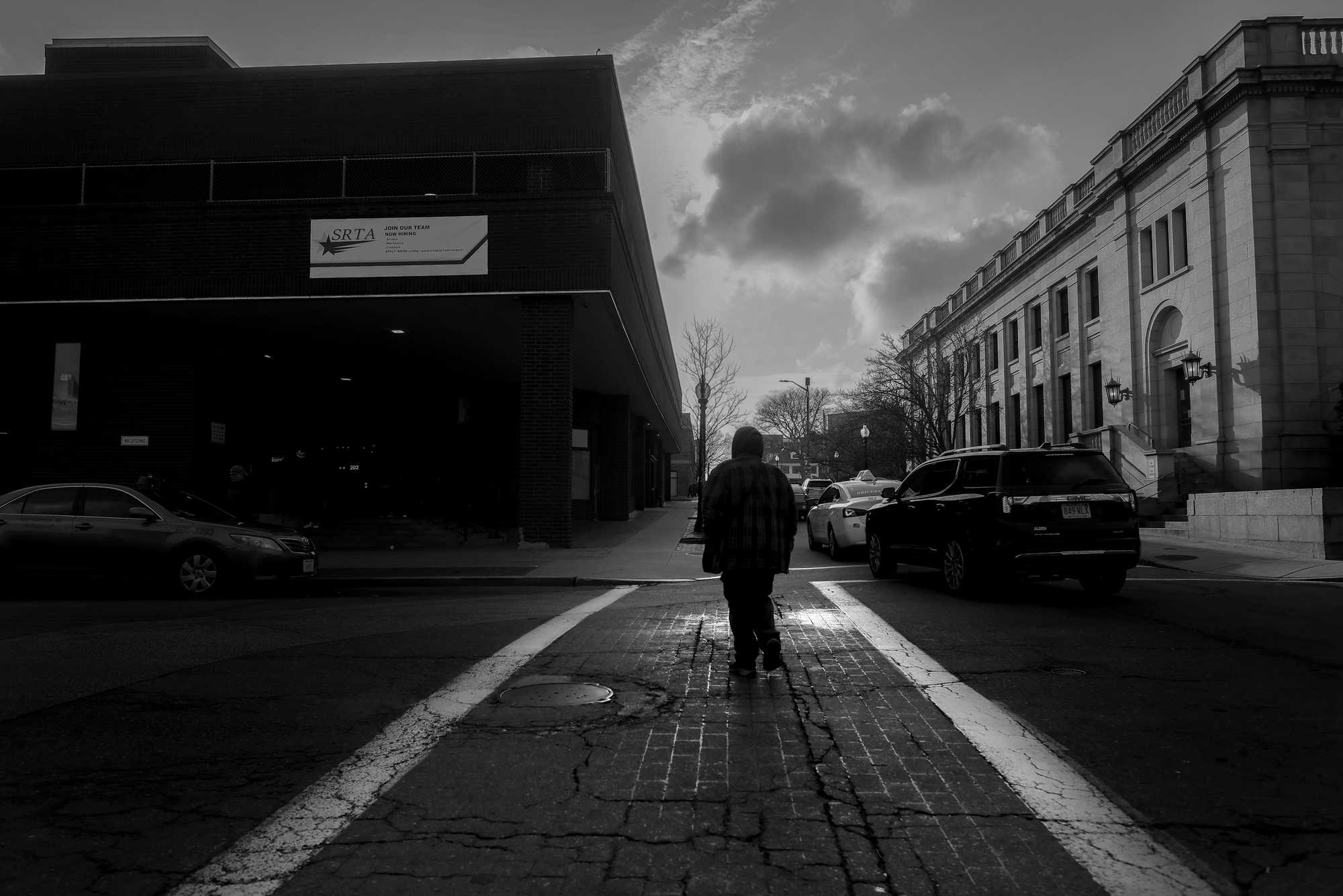 A man walked the streets near the bus station in downtown New Bedford.