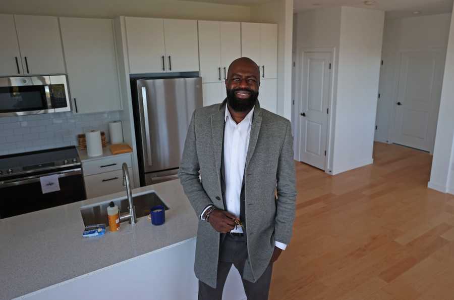 Boston, MA - 10/23/23: xxcureall ....... New home owner, Murad Wornum (CQ)  with keys in hand stands in his new home. There was a Ribbon Cutting for 40 Affordable Homeownership Units in Roxbury, a new development project that specifically aims to target people from Roxbury, to build wealth in that community. The Saige on Fountain at 25 Fountain Street, Roxbury MA.  MassHousing, City of Boston Mayors Office of Housing  and Oxbow Urban DVM Housing Partners were involved in the project.  (David L Ryan/Globe Staff ) SECTION:  METRO 
