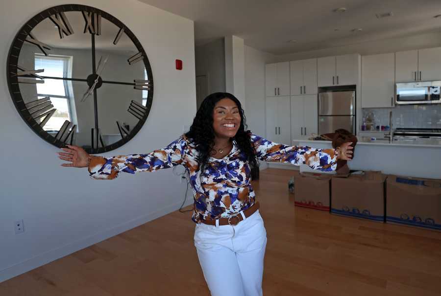 Boston, MA - 10/23/23: xxcureall ....... Her smile tells it all… Aisha Virgo (CQ) standing in her new home. There was a Ribbon Cutting for 40 Affordable Homeownership Units in Roxbury, a new development project that specifically aims to target people from Roxbury, to build wealth in that community. The Saige on Fountain at 25 Fountain Street, Roxbury MA.  MassHousing, City of Boston Mayors Office of Housing  and Oxbow Urban DVM Housing Partners were involved in the project.  (David L Ryan/Globe Staff ) SECTION:  METRO 