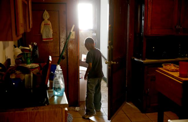 Stacey Hodges Harmon's son Camrin Euell, 8, opened the back door to his apartment building on the North Side of Milwaukee.
