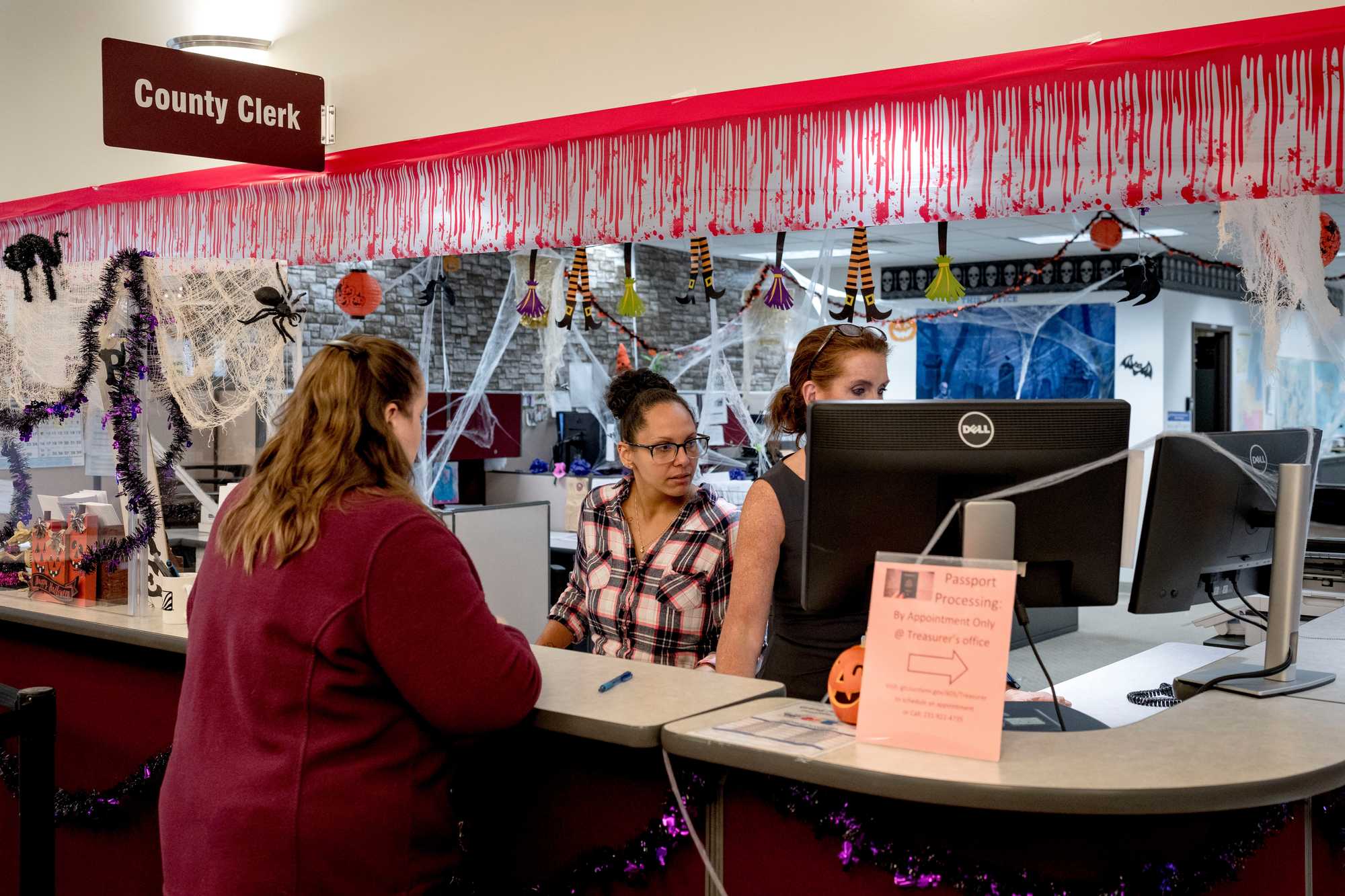 From left, Katrina McGinnis of Traverse City talked with deputy clerks Rachel Jarrett and Christine Coil at the Grand Traverse County Clerk’s Office at Governmental Center in Traverse City, Mich.