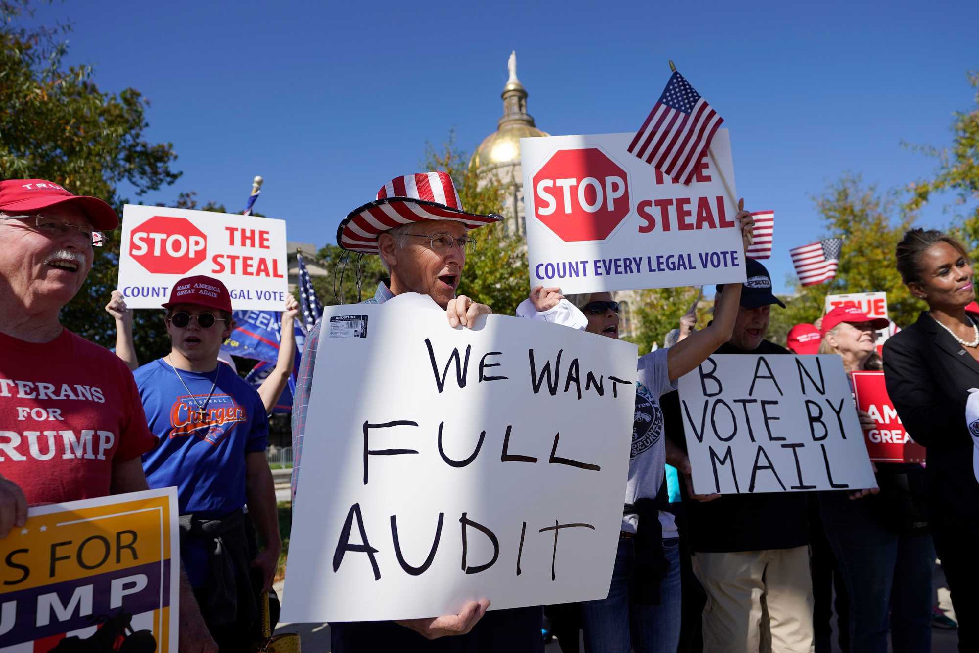 Supporters of President Trump held signs during a rally outside the Georgia Capitol on Nov. 13, 2020, in Atlanta.