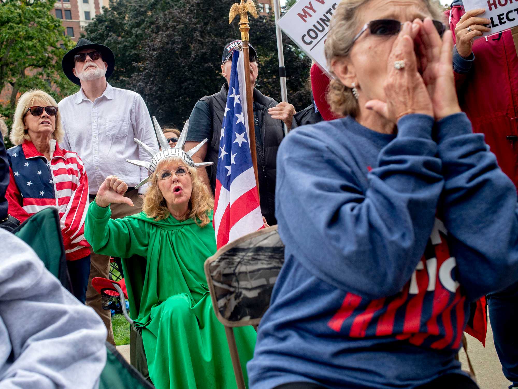 Macomb County resident Carol Reed booed while wearing a "Lady Liberty" costume along with Judy Adams, of Durand, during a rally at the Michigan State Capitol on Oct. 12, 2021, in Lansing. The event, organized by a group called Election Integrity Fund and Force, was demanding a "forensic audit" of the state's 2020 presidential election results. 