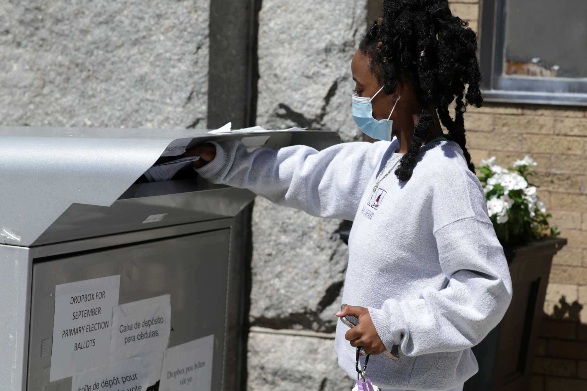 Zanyah Zorseuille mailed a ballot for a family member at a voting box outside of Brockton City Hall before the Sept. 1  primary election on Aug. 26, 2020. 