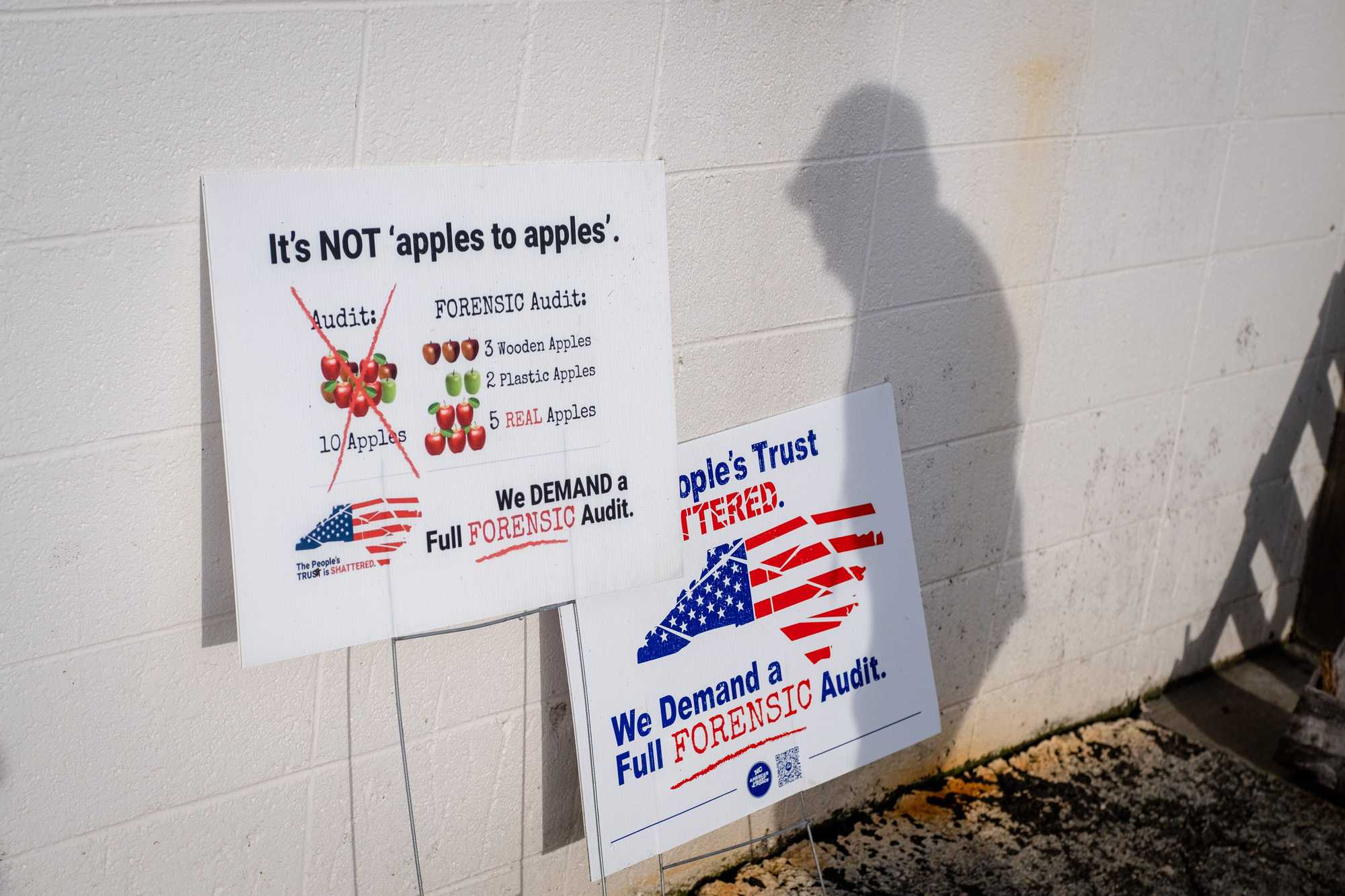 Signs promoting election lies about the 2020 presidential election left behind the Surry County Board of Elections in Dobson, N.C.
