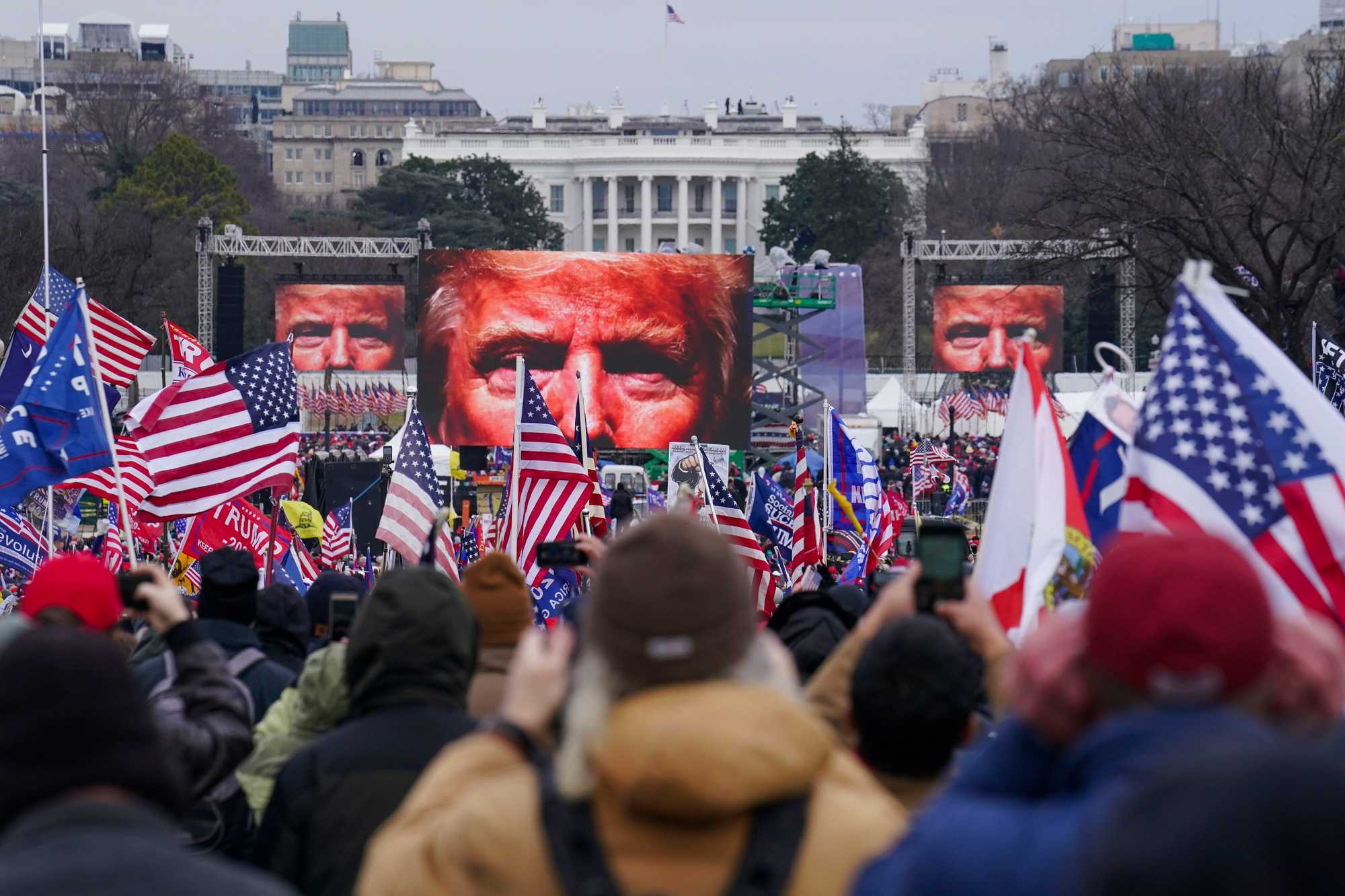 The face of then-president Trump appeared on large screens as supporters participated in a rally in Washington, D.C., on Jan. 6, 2021.