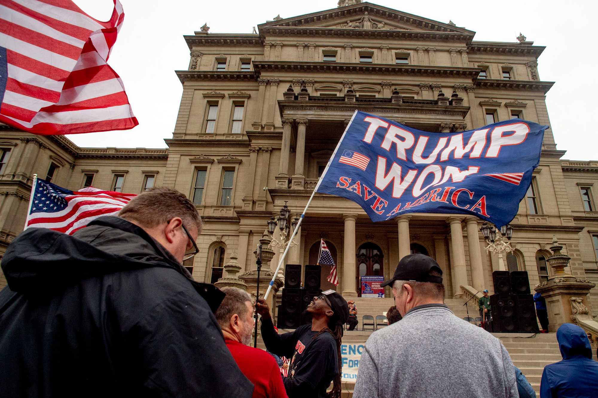 A protester waved a Trump flag during a rally at the Michigan State Capitol on Oct. 12, 2021, in Lansing. The event, organized by a group called Election Integrity Fund and Force, was demanding a "forensic audit" of the state's 2020 presidential election results.