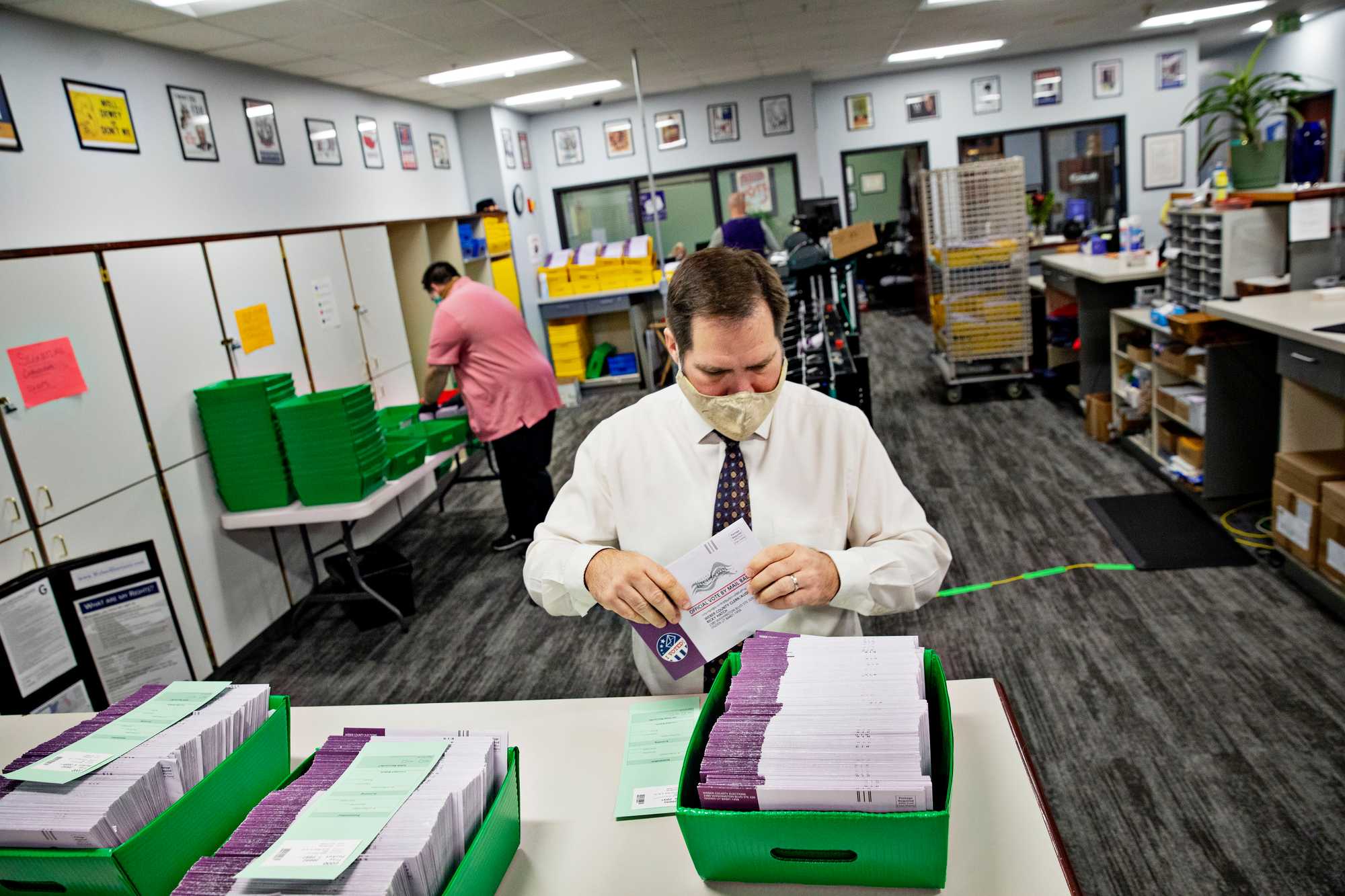 Weber County Clerk and Auditor Ricky Hatch helped organize mail-in ballots at the Weber County Clerk's Office in Ogden, Utah, Oct. 23, 2020. 