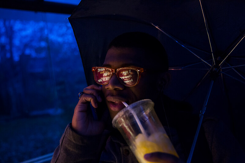 Coppin Academy student Na’im Smith waits for his bus to take him to school in Baltimore.