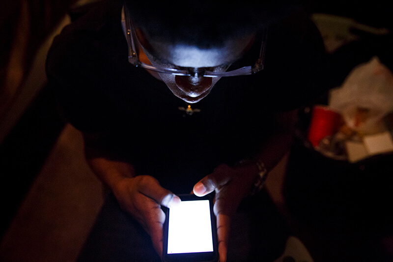 Connexions High School student Da’Shawn Simon writes songs on his mobile phone in his room.